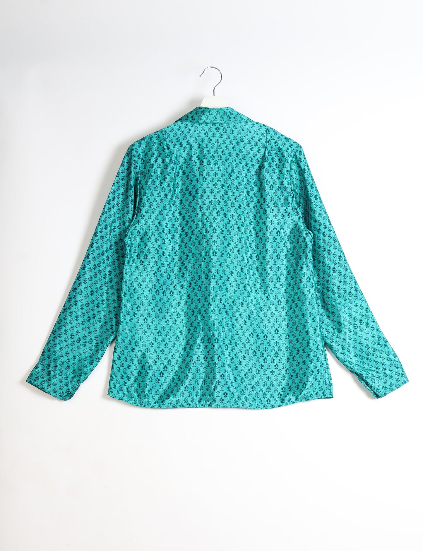 Experience sustainable fashion with our classic slim-fit shirt, crafted with ethical and green values. The shirt, designed for minimal waste, features a tie-up waist belt or neck tie, semi-spread collar, and regular shirt cuffs. Versatile and eco-friendly, wear it tucked in, unbuttoned over a tank top, or knotted at the waist for a unique style.