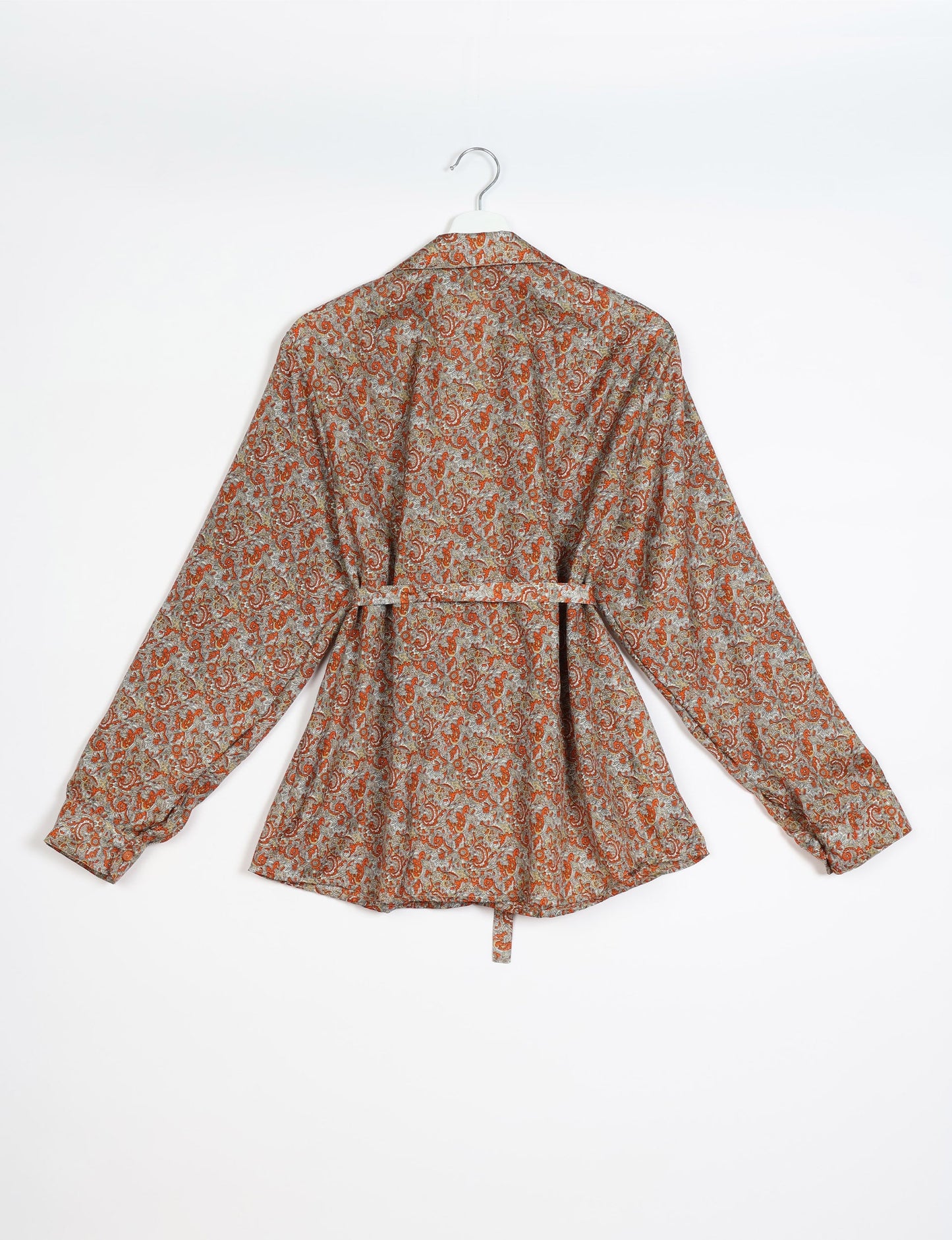 Experience sustainable fashion with our classic slim-fit shirt, crafted with ethical and green values. The shirt, designed for minimal waste, features a tie-up waist belt or neck tie, semi-spread collar, and regular shirt cuffs. Versatile and eco-friendly, wear it tucked in, unbuttoned over a tank top, or knotted at the waist for a unique style.