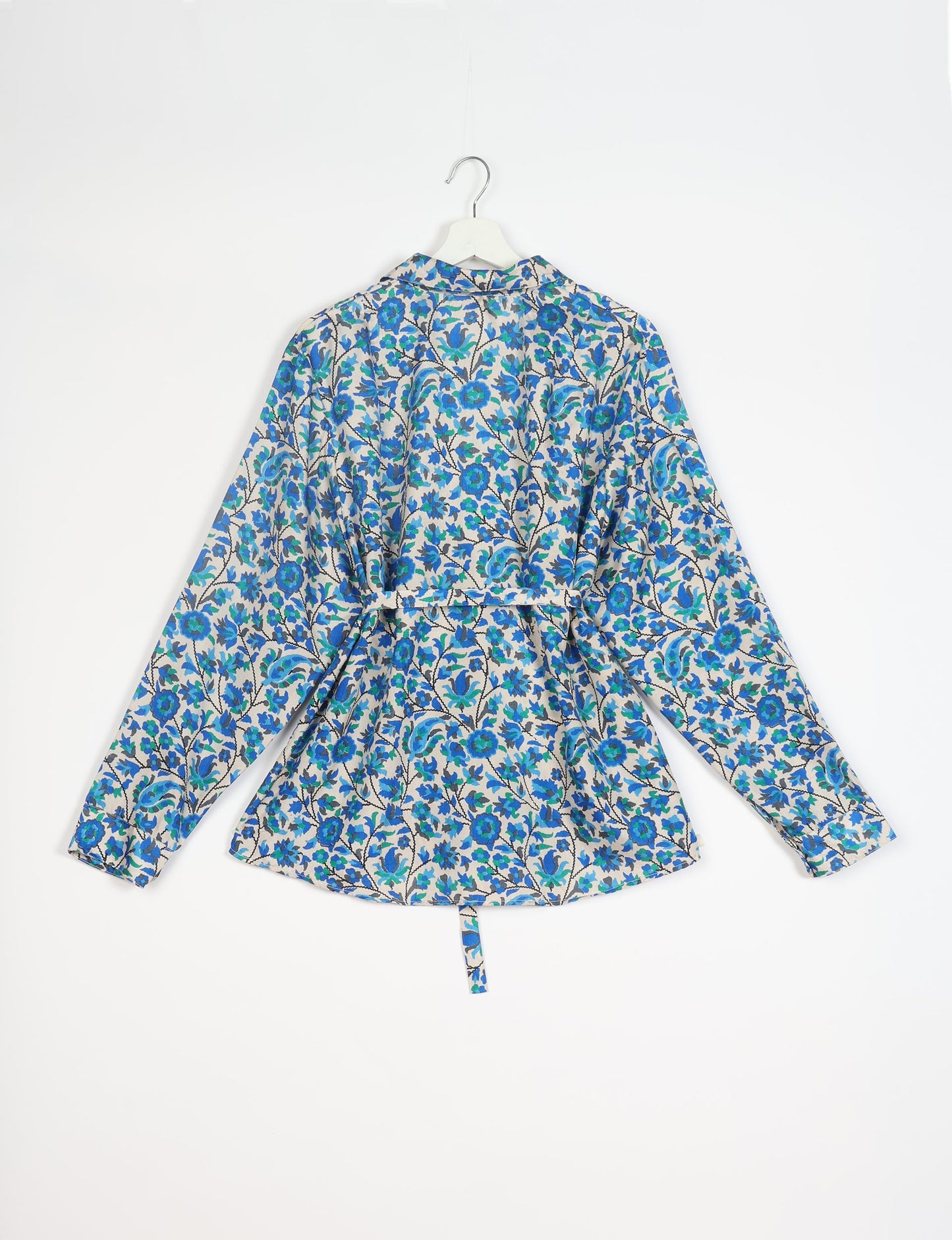 Experience sustainable fashion with our classic slim-fit shirt, crafted with ethical and green values. The shirt, designed for minimal waste, features a tie-up waist belt or neck tie, semi-spread collar, and regular shirt cuffs. Versatile and eco-friendly, wear it tucked in, unbuttoned over a tank top, or knotted at the waist for a unique style.