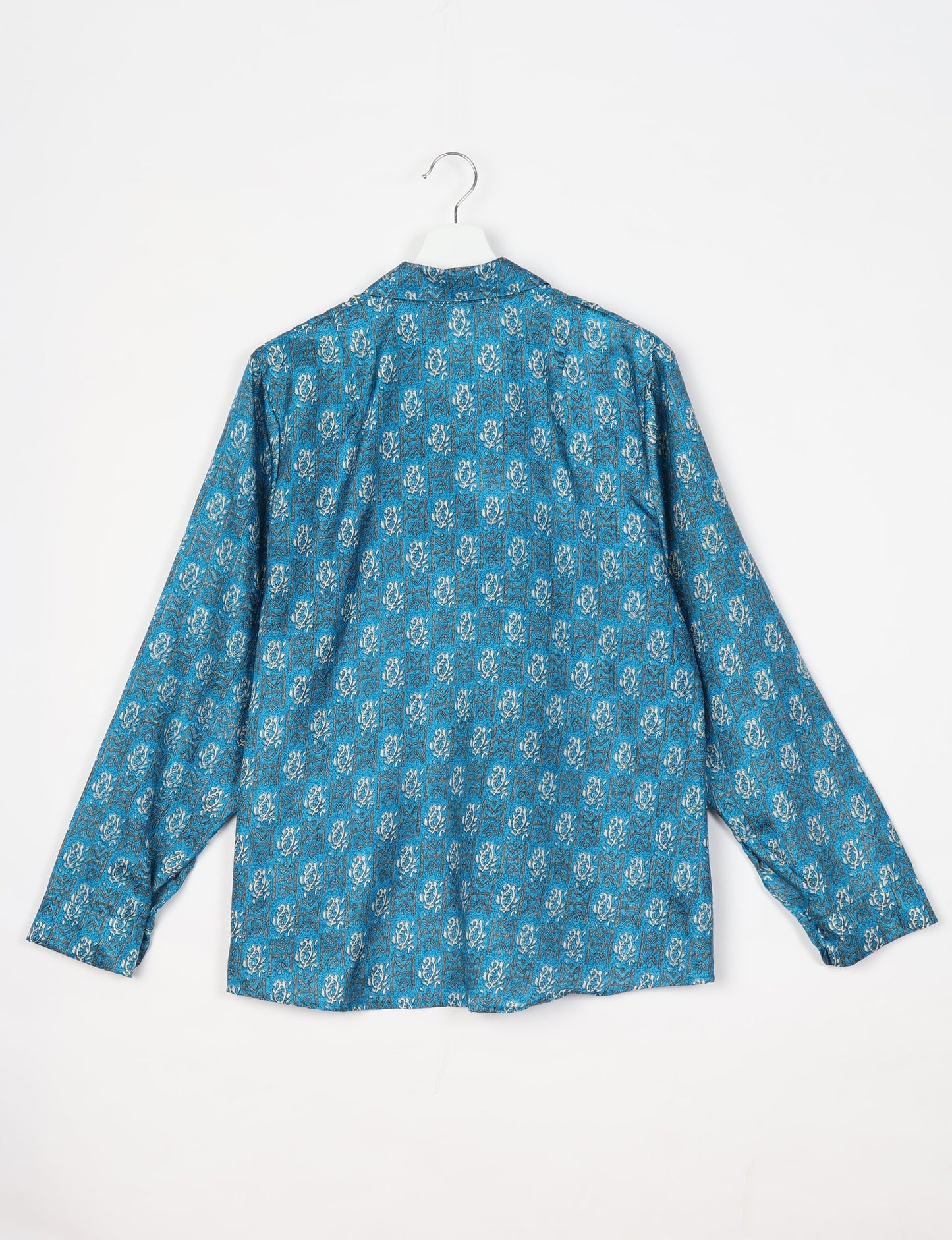 Experience sustainable fashion with our classic slim-fit shirt, crafted with ethical and green values. The shirt, designed for minimal waste, features a tie-up waist belt or neck tie, semi-spread collar, and regular shirt cuffs. Versatile and eco-friendly, wear it tucked in, unbuttoned over a tank top, or knotted at the waist for a unique style.