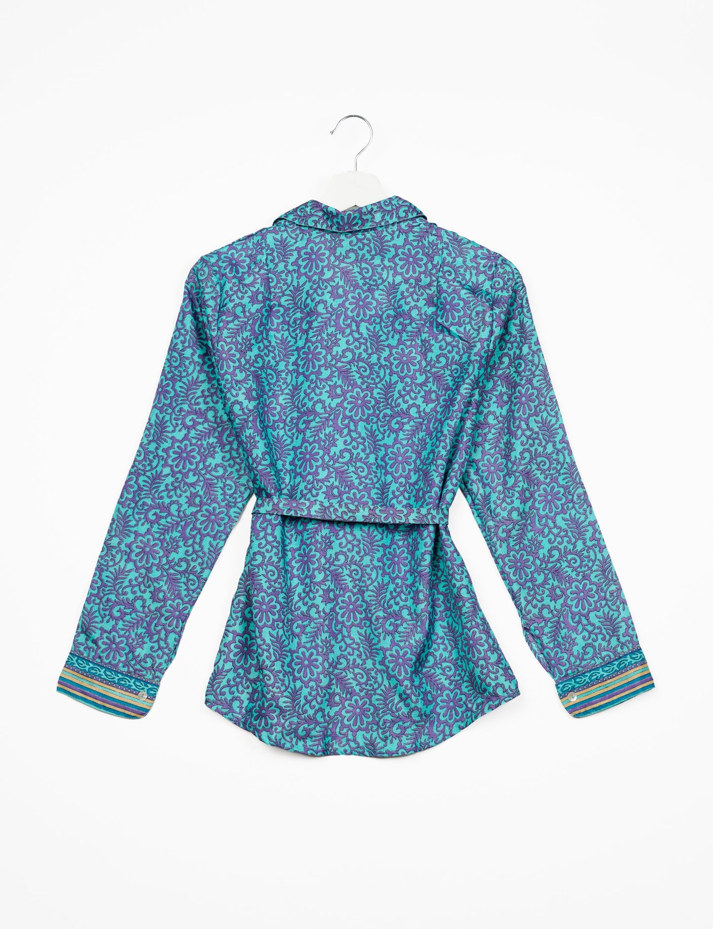 Experience sustainable fashion with our classic slim-fit shirt, crafted with ethical and green values. The shirt, designed for minimal waste, features a tie-up waist belt or neck tie, semi-spread collar, and regular shirt cuffs. Versatile and eco-friendly, wear it tucked in, unbuttoned over a tank top, or knotted at the waist for a unique style.