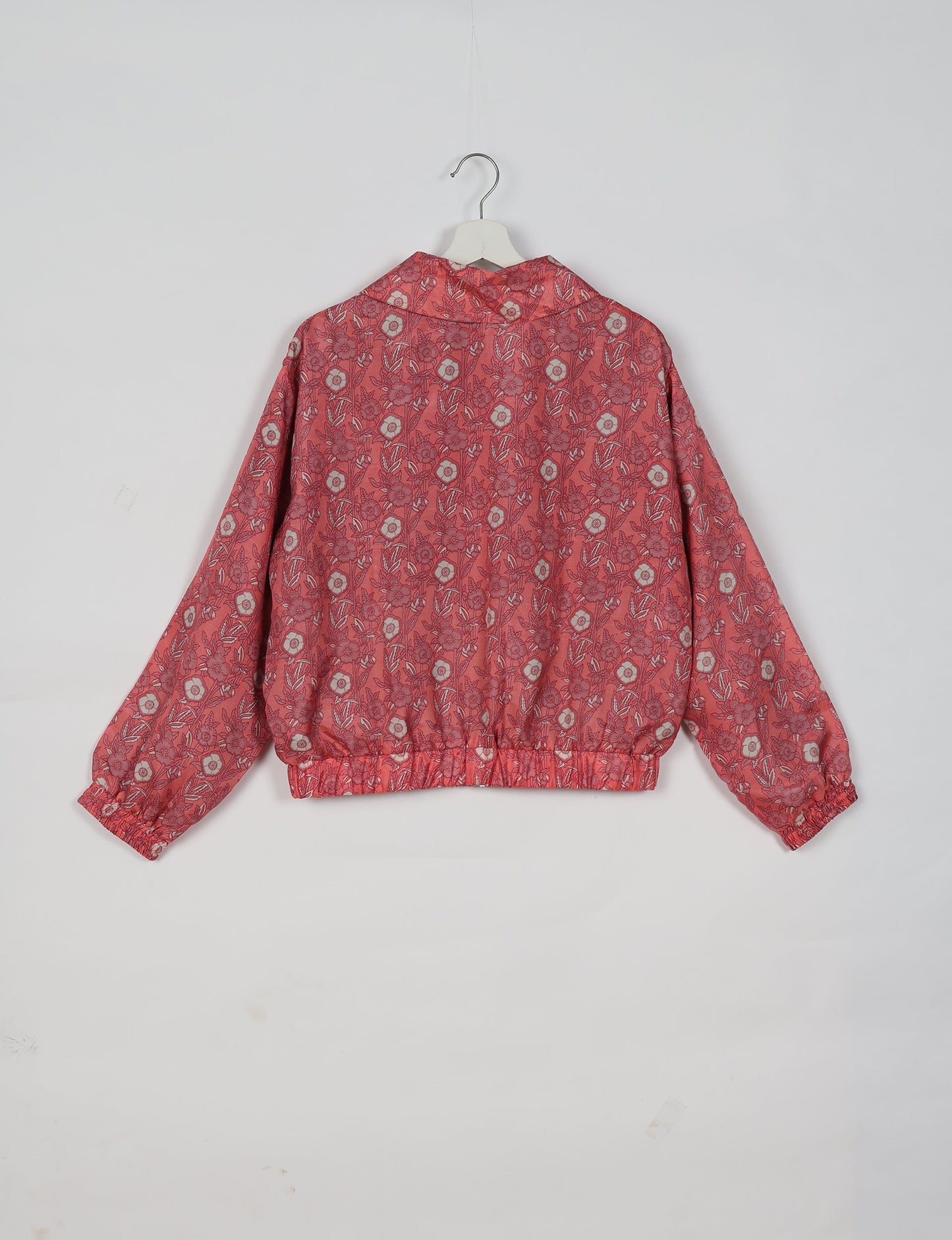 Upcycled Bomber Jacket made from recycled sari materials, featuring a cute cropped shape, elasticated hem and cuffs, and contrast sari print lining. Sustainable apparel promoting eco-friendly fashion and ethical clothing.