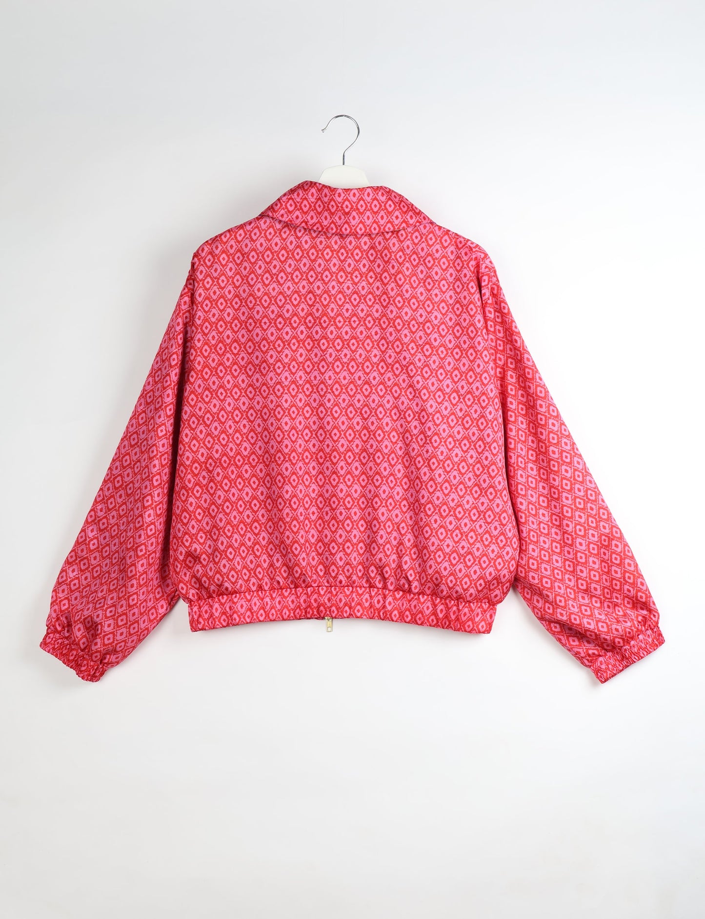 Upcycled Bomber Jacket made from recycled sari materials, featuring a cute cropped shape, elasticated hem and cuffs, and contrast sari print lining. Sustainable apparel promoting eco-friendly fashion and ethical clothing.