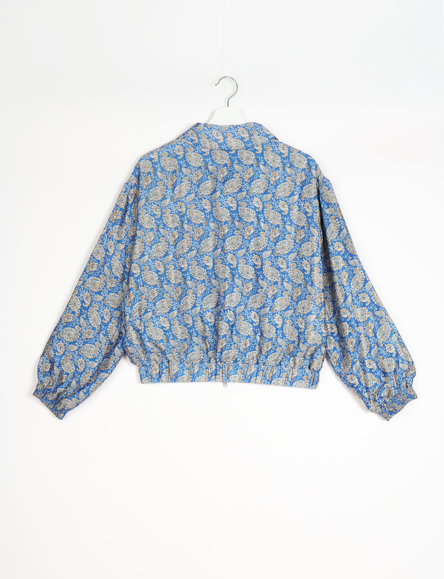 Stylish BOMBER JACKET, an upcycled clothing masterpiece with a cute cropped shape, elasticated details, and detachable metallic zipper. Contrast sari print lining adds a unique touch. Explore sustainable and eco-friendly fashion.