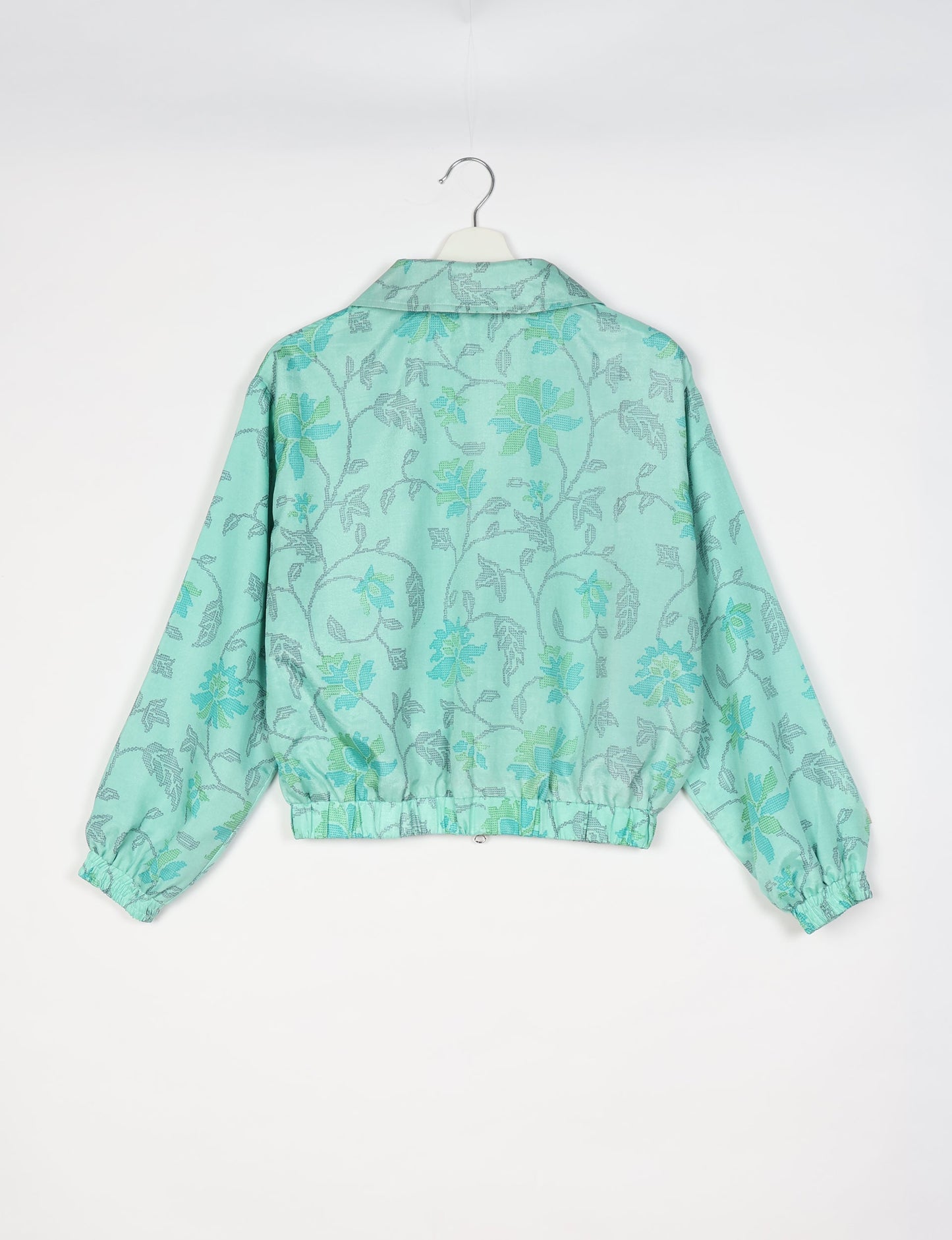 Upcycled Bomber Jacket made from recycled sari materials, featuring a cute cropped shape, elasticated hem and cuffs, and contrast sari print lining. Sustainable apparel promoting eco-friendly fashion and ethical clothing.