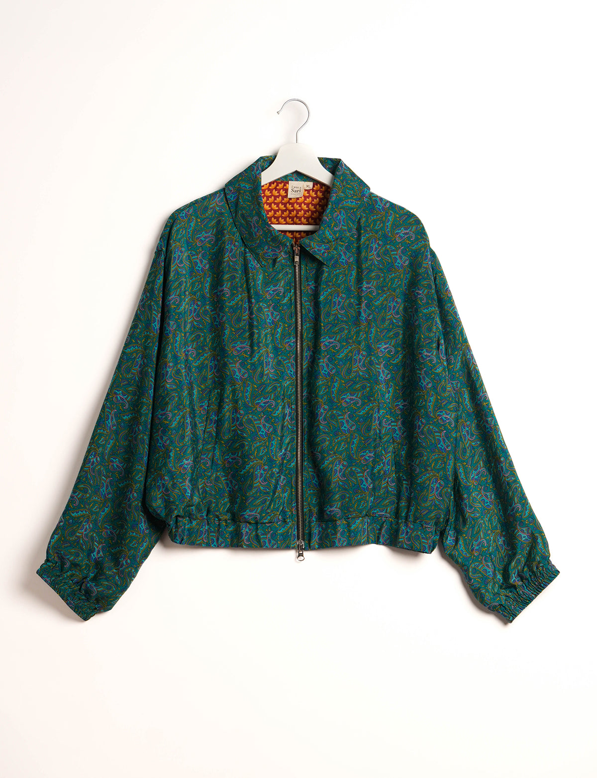 Stylish BOMBER JACKET, an upcycled clothing masterpiece with a cute cropped shape, elasticated details, and detachable metallic zipper. Contrast sari print lining adds a unique touch. Explore sustainable and eco-friendly fashion.