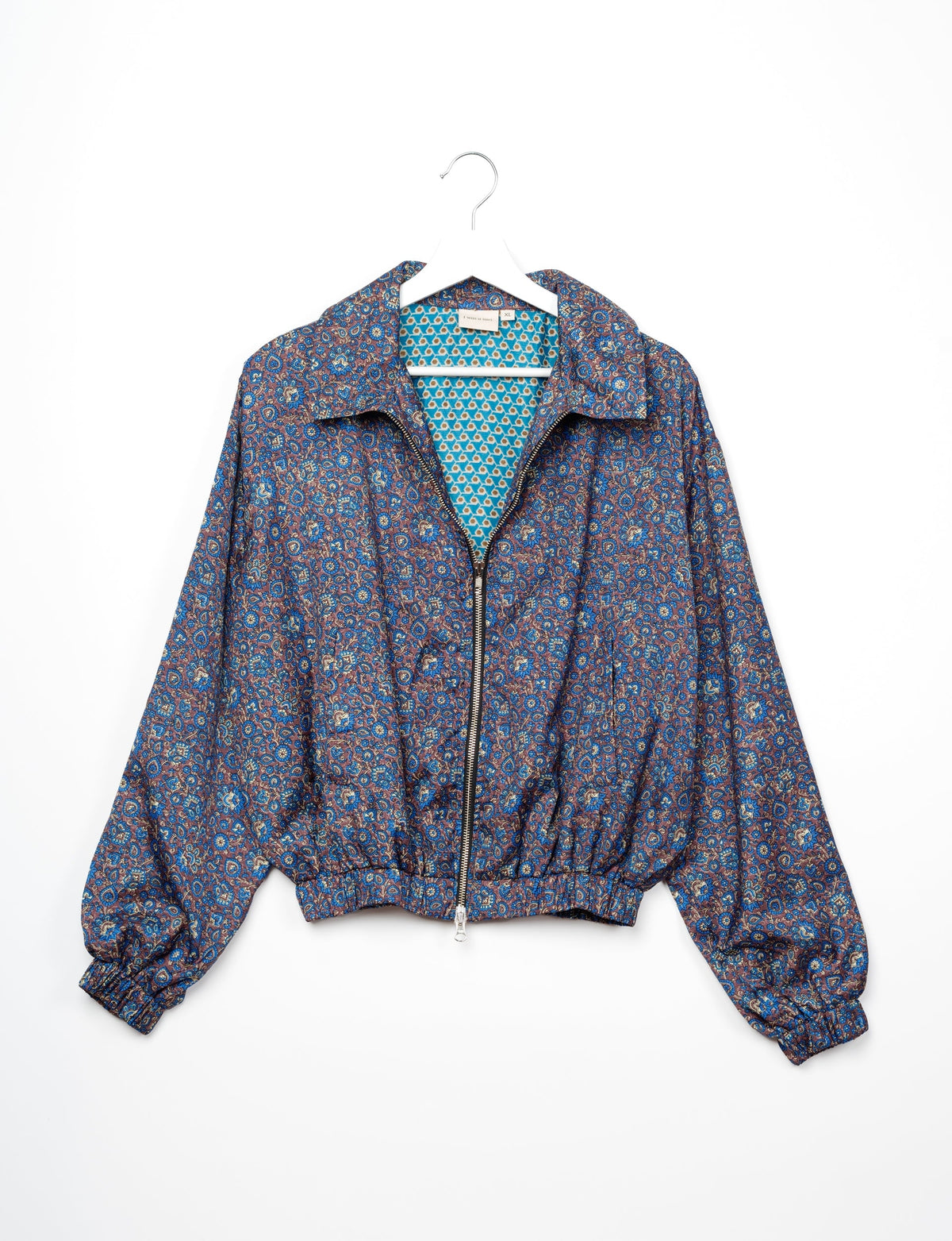 Stylish BOMBER JACKET, an upcycled clothing masterpiece with a cute cropped shape, elasticated details, and detachable metallic zipper. Contrast sari print lining adds a unique touch. Explore sustainable and eco-friendly fashion.