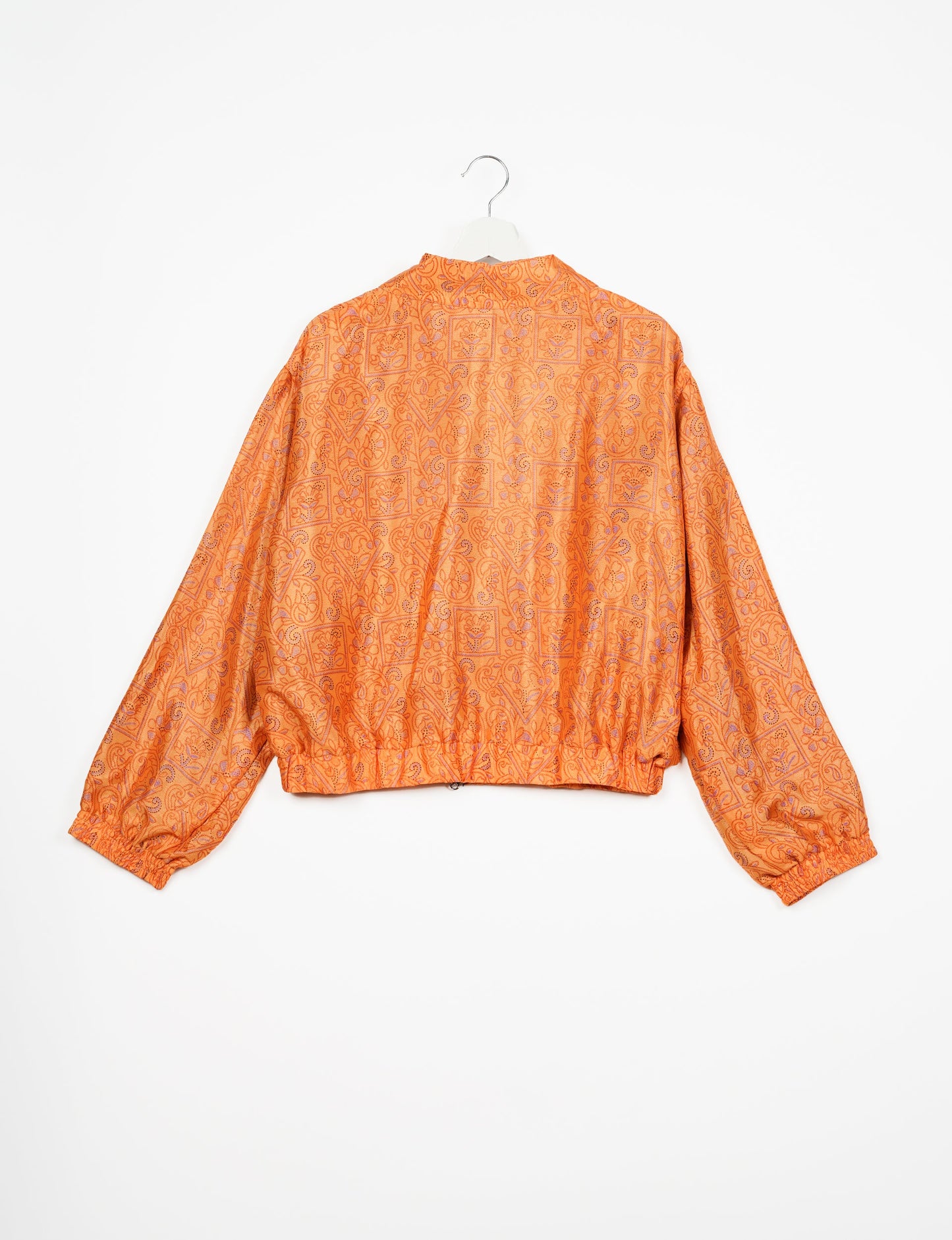 Stylish BOMBER JACKET, an upcycled clothing masterpiece with a cute cropped shape, elasticated details, and detachable metallic zipper. Contrast sari print lining adds a unique touch. Explore sustainable and eco-friendly fashion.