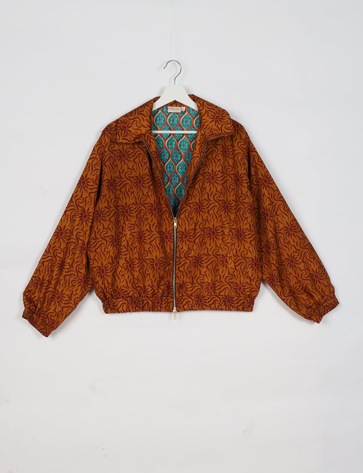 Upcycled Bomber Jacket made from recycled sari materials, featuring a cute cropped shape, elasticated hem and cuffs, and contrast sari print lining. Sustainable apparel promoting eco-friendly fashion and ethical clothing.