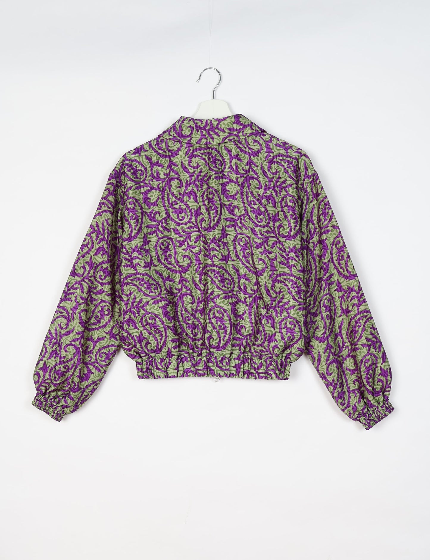 Upcycled Bomber Jacket made from recycled sari materials, featuring a cute cropped shape, elasticated hem and cuffs, and contrast sari print lining. Sustainable apparel promoting eco-friendly fashion and ethical clothing.