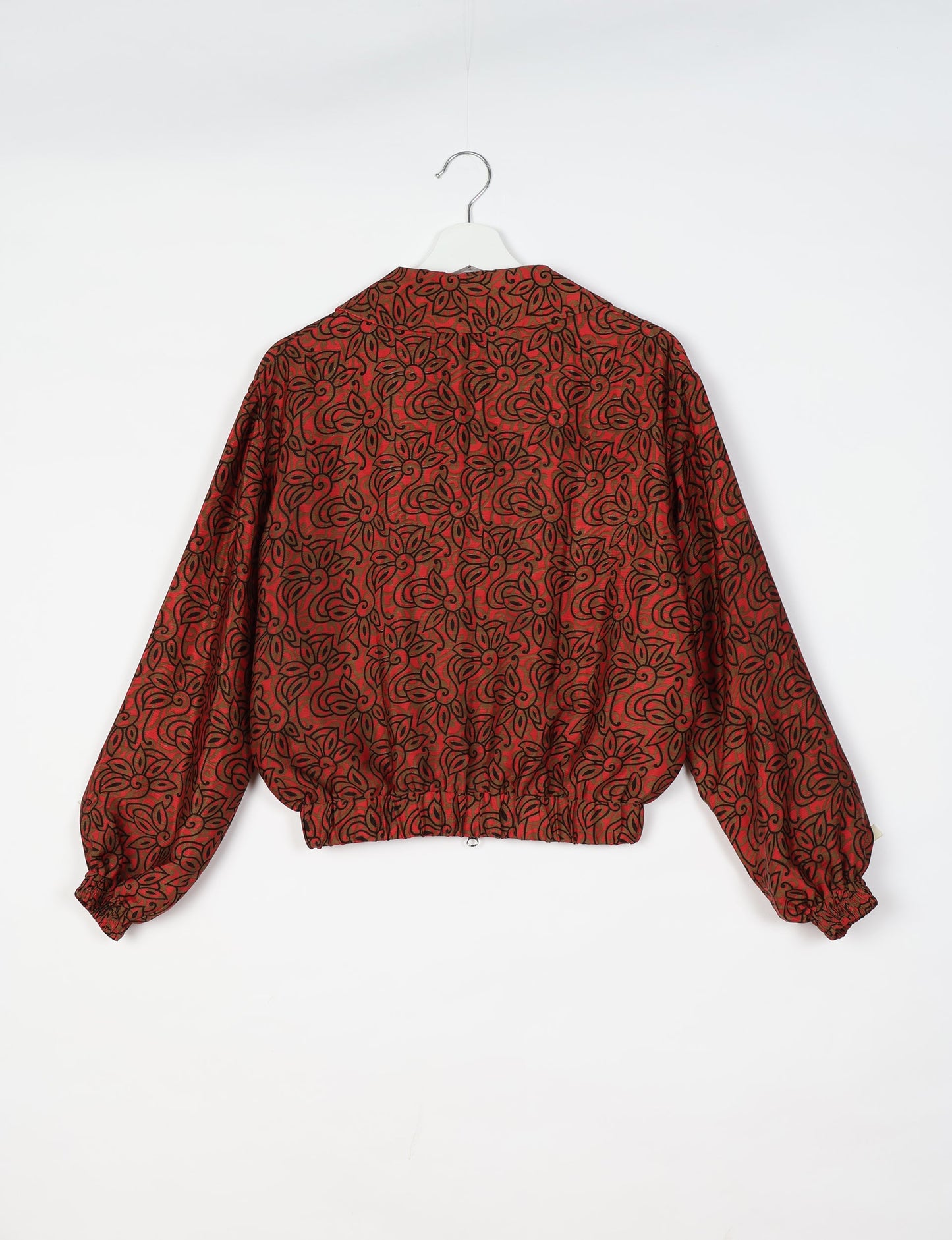 Upcycled Bomber Jacket made from recycled sari materials, featuring a cute cropped shape, elasticated hem and cuffs, and contrast sari print lining. Sustainable apparel promoting eco-friendly fashion and ethical clothing.