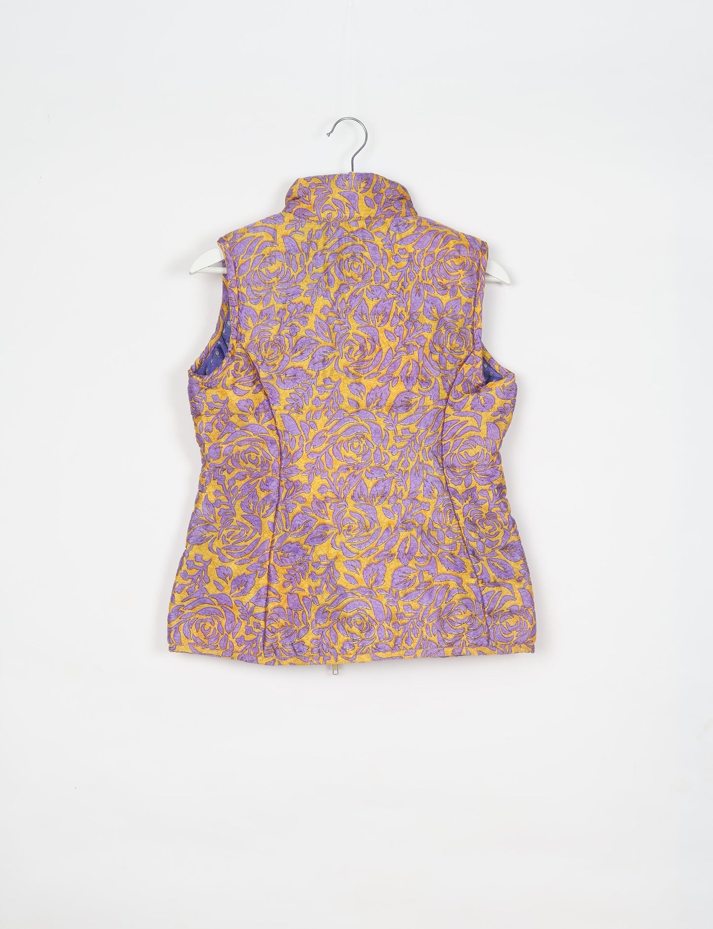 Elevate your style with our QUILTED GILET, crafted from upcycled tropical saris. This sleeveless jacket, with its quilted warmth, is perfect for layering over tees or sweaters. Choose ethical, green fashion and experience the comfort of sustainable living with a touch of home.