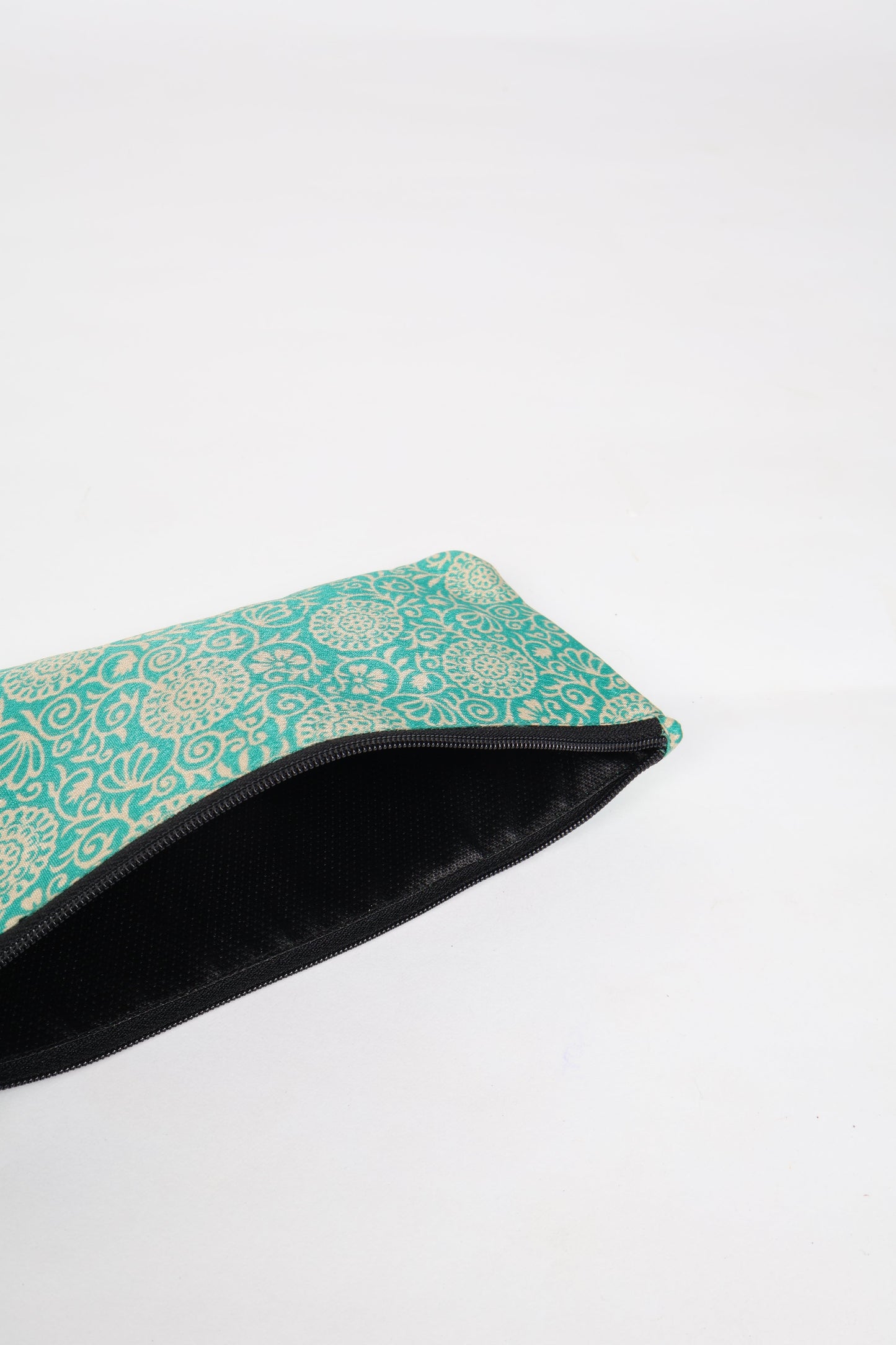 Eco-conscious quilted pencil pouch with waterproof lining made from upcycled garments, reflecting the values of circular fashion, carbon neutral fashion, and repurposed clothing. A perfect example of green fashion and sustainable women's clothing.