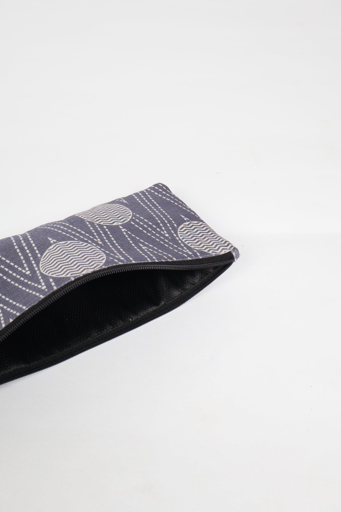 Eco-conscious quilted pencil pouch with waterproof lining made from upcycled garments, reflecting the values of circular fashion, carbon neutral fashion, and repurposed clothing. A perfect example of green fashion and sustainable women's clothing.