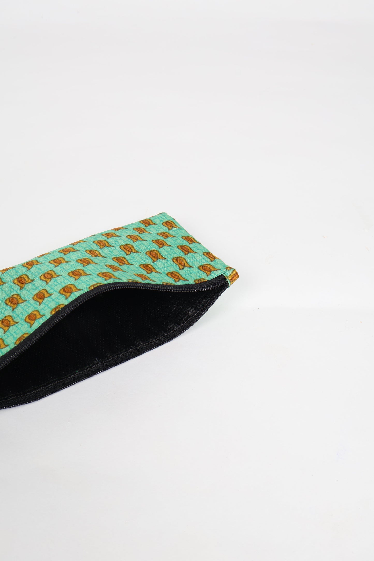 Eco-conscious quilted pencil pouch with waterproof lining made from upcycled garments, reflecting the values of circular fashion, carbon neutral fashion, and repurposed clothing. A perfect example of green fashion and sustainable women's clothing.