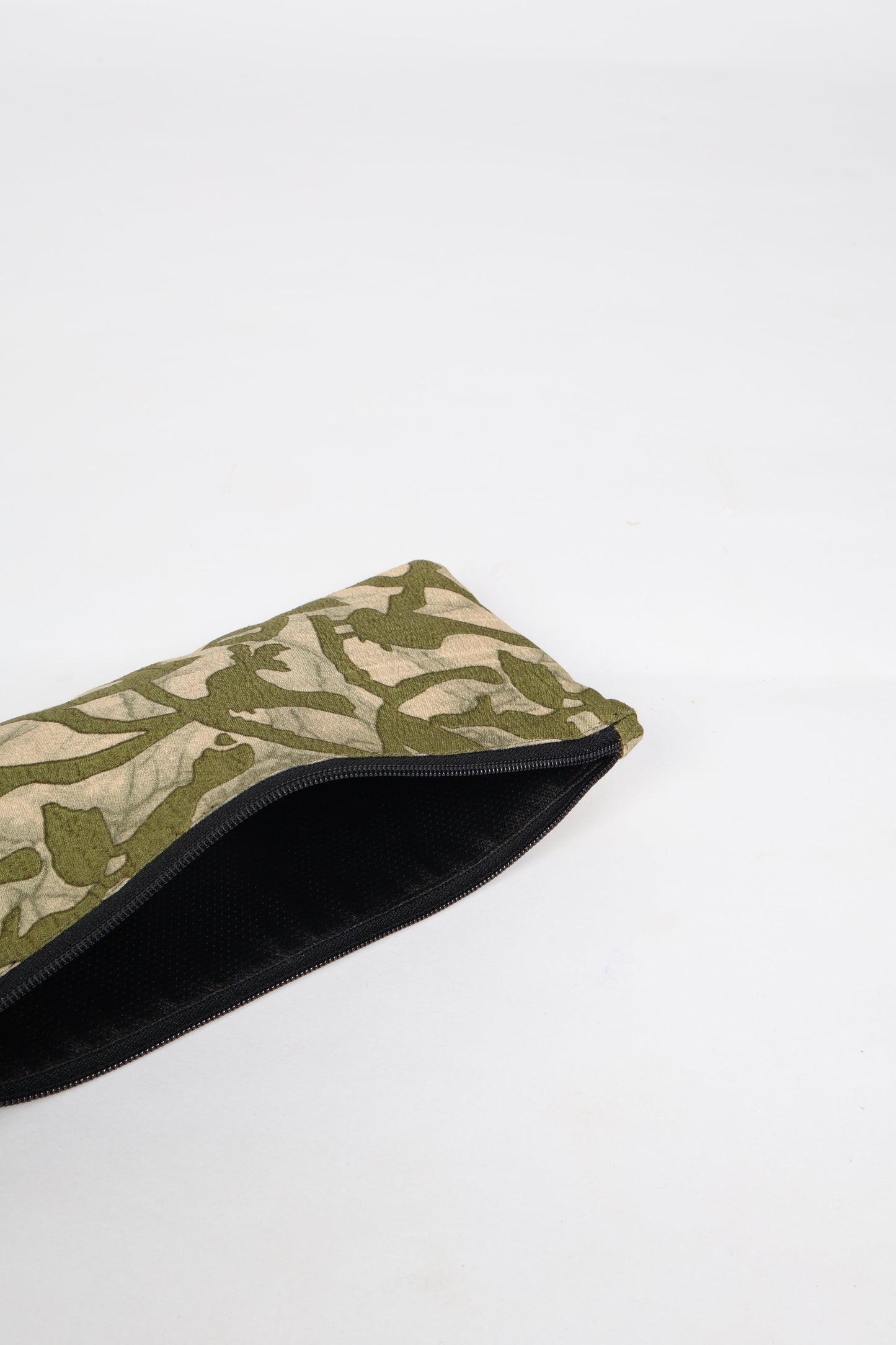 Eco-conscious quilted pencil pouch with waterproof lining made from upcycled garments, reflecting the values of circular fashion, carbon neutral fashion, and repurposed clothing. A perfect example of green fashion and sustainable women's clothing.