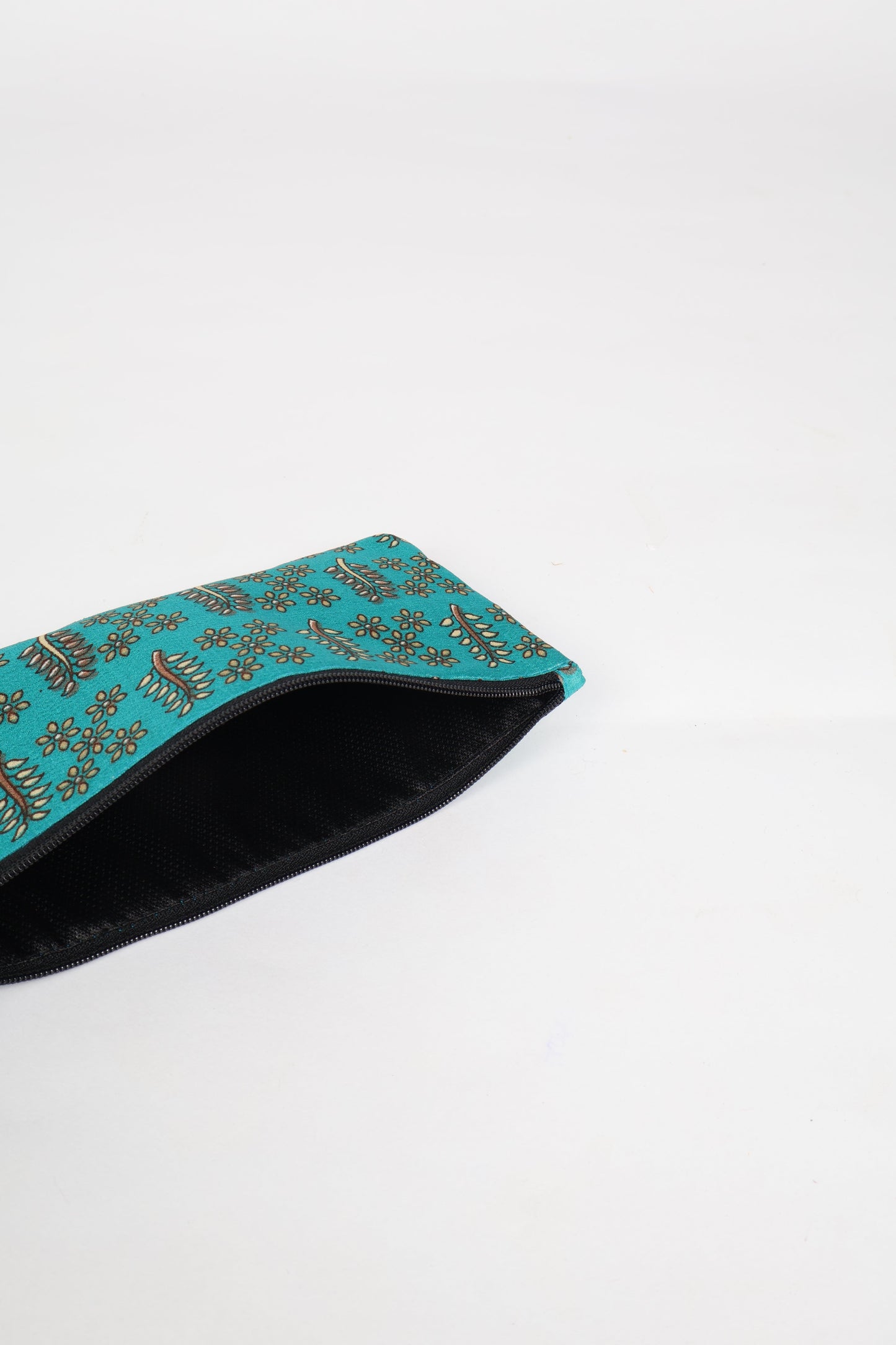 Eco-conscious quilted pencil pouch with waterproof lining made from upcycled garments, reflecting the values of circular fashion, carbon neutral fashion, and repurposed clothing. A perfect example of green fashion and sustainable women's clothing.