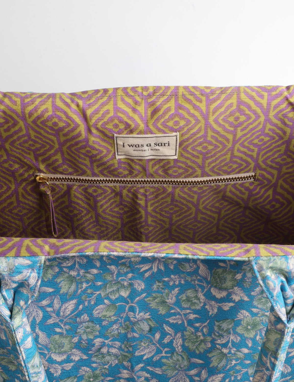Grey floral fabric work tote bag with blue and beige flowers, teal interior lining with beige polka dots, and fabric handles