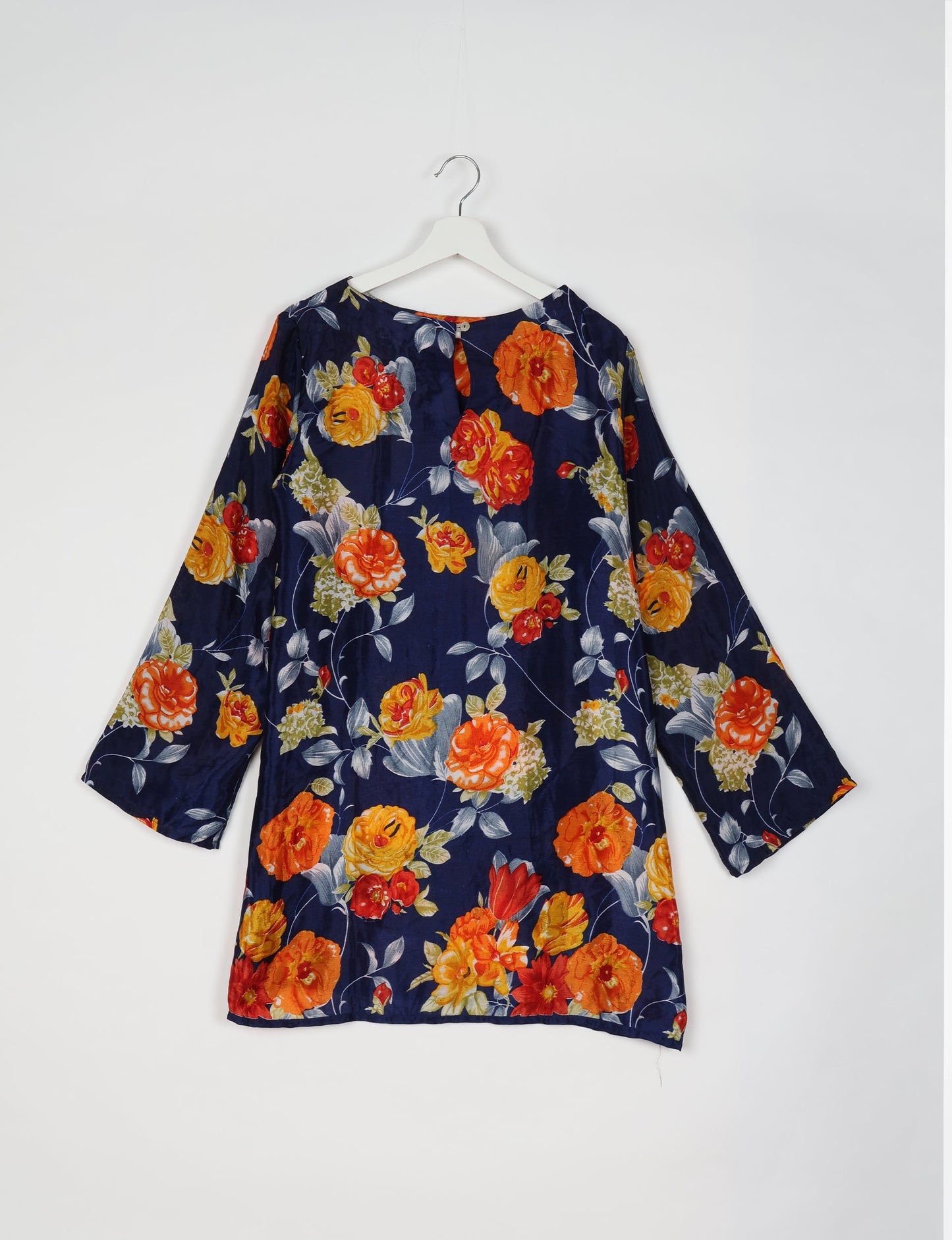 Chic and conscious, our A-line mini swing dress is a must-have in sustainable fashion. Adorned with flared sleeves, a keyhole back opening, and a mother of pearl button with twill tape loop. This zero waste, upcycled garment reflects the essence of eco-friendly and ethical clothing.