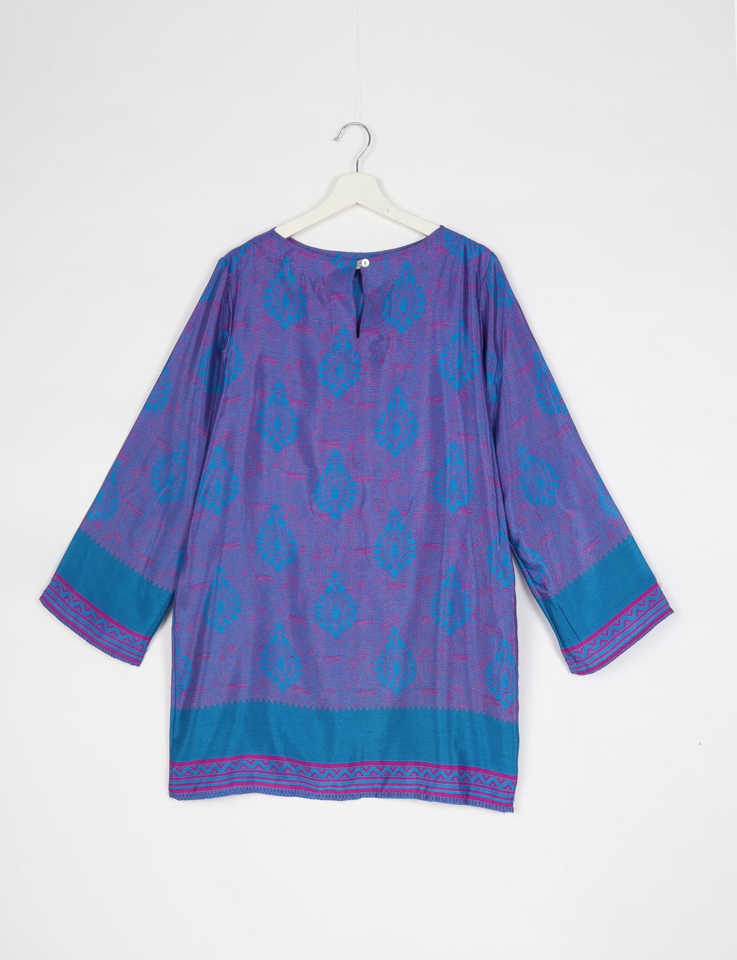 Chic and conscious, our A-line mini swing dress is a must-have in sustainable fashion. Adorned with flared sleeves, a keyhole back opening, and a mother of pearl button with twill tape loop. This zero waste, upcycled garment reflects the essence of eco-friendly and ethical clothing.