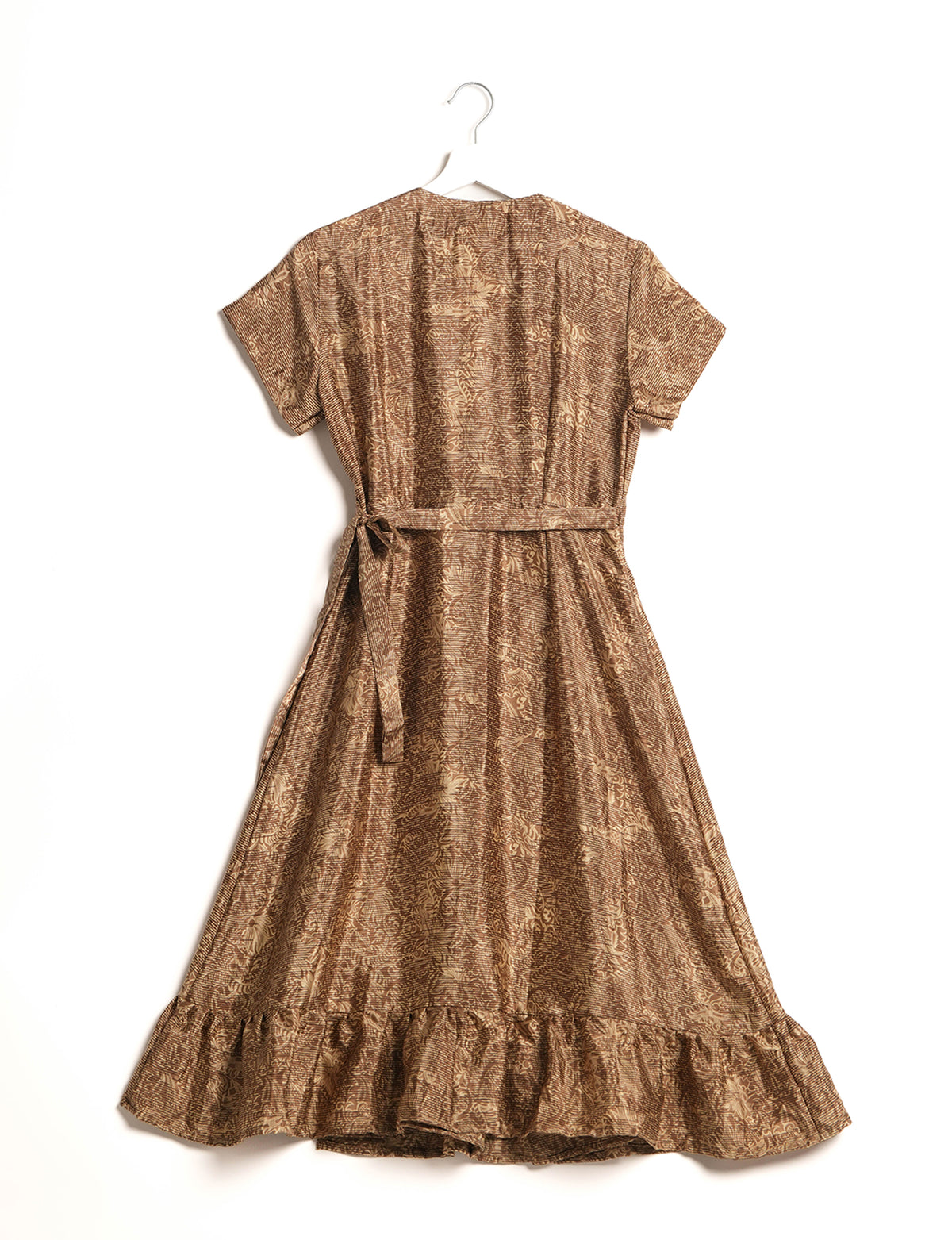 Embrace timeless elegance with our MIDI WRAP DRESS – a midi-length beauty featuring a v-neck, flattery from all angles, and a charming sari belt. Crafted from sustainable materials, this dress embodies ethical clothing and green fashion. Sophisticated with a frill tier at the hem and short cap sleeves, this dress is perfect for any occasion. Tie up the beautifully crafted sari belt on the side for a versatile, stylish, and eco-friendly look.