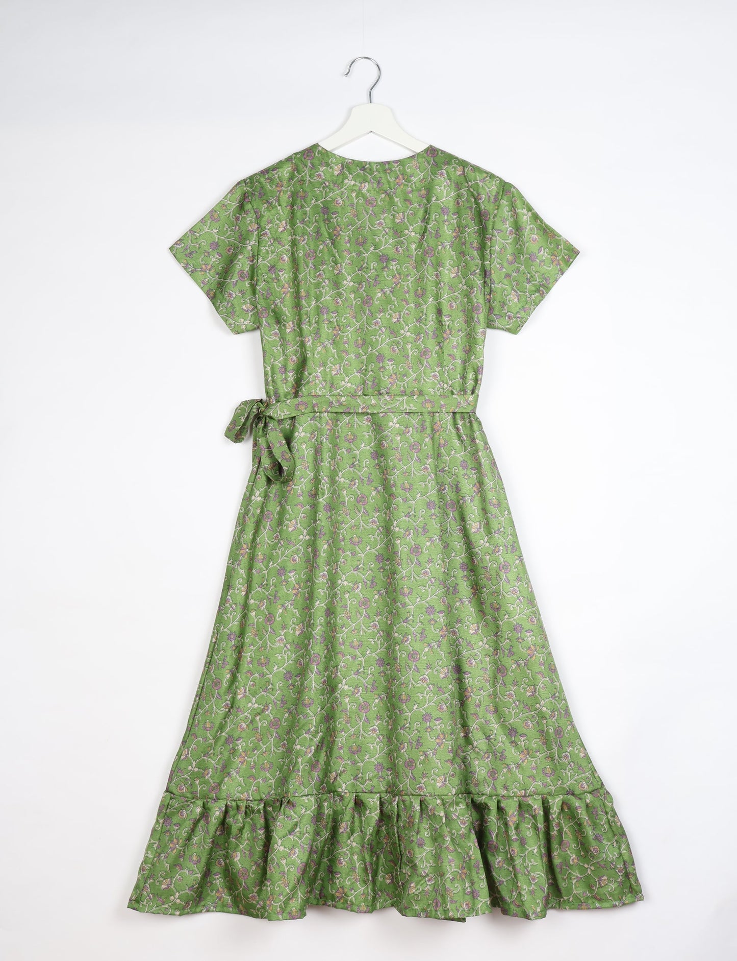 Embrace timeless elegance with our MIDI WRAP DRESS – a midi-length beauty featuring a v-neck, flattery from all angles, and a charming sari belt. Crafted from sustainable materials, this dress embodies ethical clothing and green fashion. Sophisticated with a frill tier at the hem and short cap sleeves, this dress is perfect for any occasion. Tie up the beautifully crafted sari belt on the side for a versatile, stylish, and eco-friendly look.