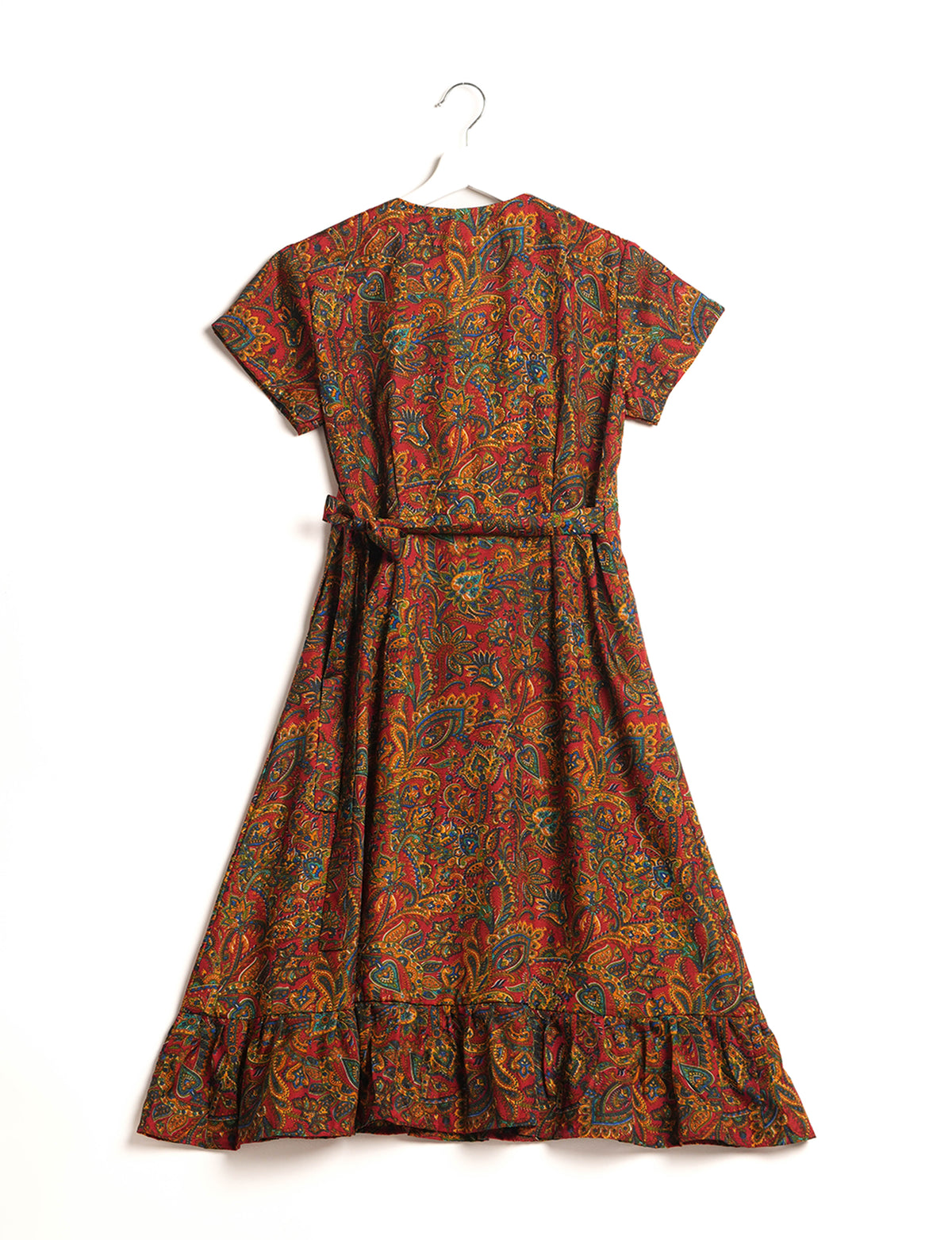 Embrace timeless elegance with our MIDI WRAP DRESS – a midi-length beauty featuring a v-neck, flattery from all angles, and a charming sari belt. Crafted from sustainable materials, this dress embodies ethical clothing and green fashion. Sophisticated with a frill tier at the hem and short cap sleeves, this dress is perfect for any occasion. Tie up the beautifully crafted sari belt on the side for a versatile, stylish, and eco-friendly look.