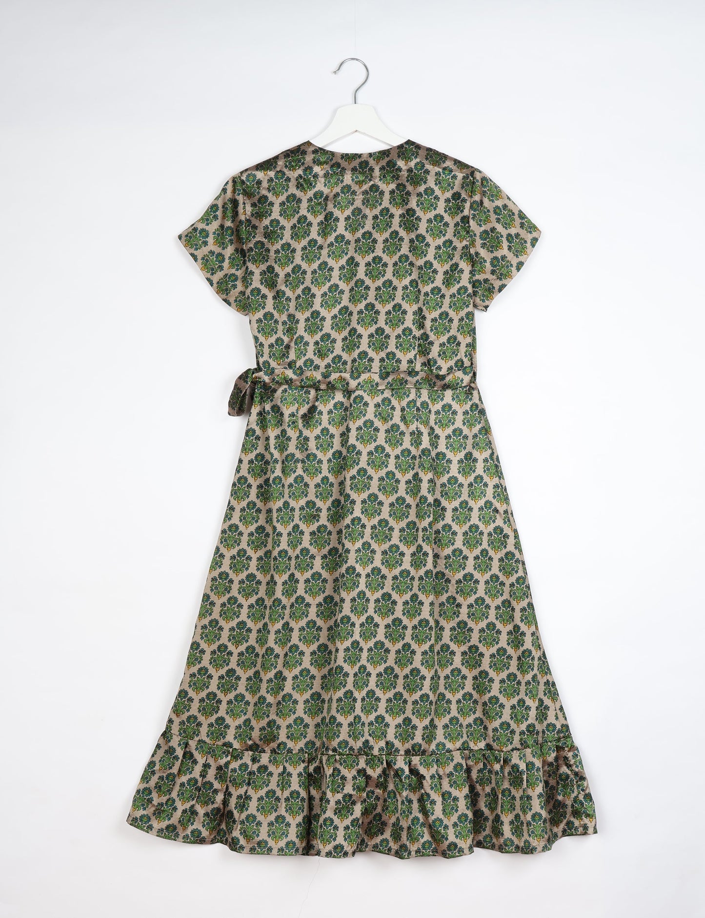 Embrace timeless elegance with our MIDI WRAP DRESS – a midi-length beauty featuring a v-neck, flattery from all angles, and a charming sari belt. Crafted from sustainable materials, this dress embodies ethical clothing and green fashion. Sophisticated with a frill tier at the hem and short cap sleeves, this dress is perfect for any occasion. Tie up the beautifully crafted sari belt on the side for a versatile, stylish, and eco-friendly look.