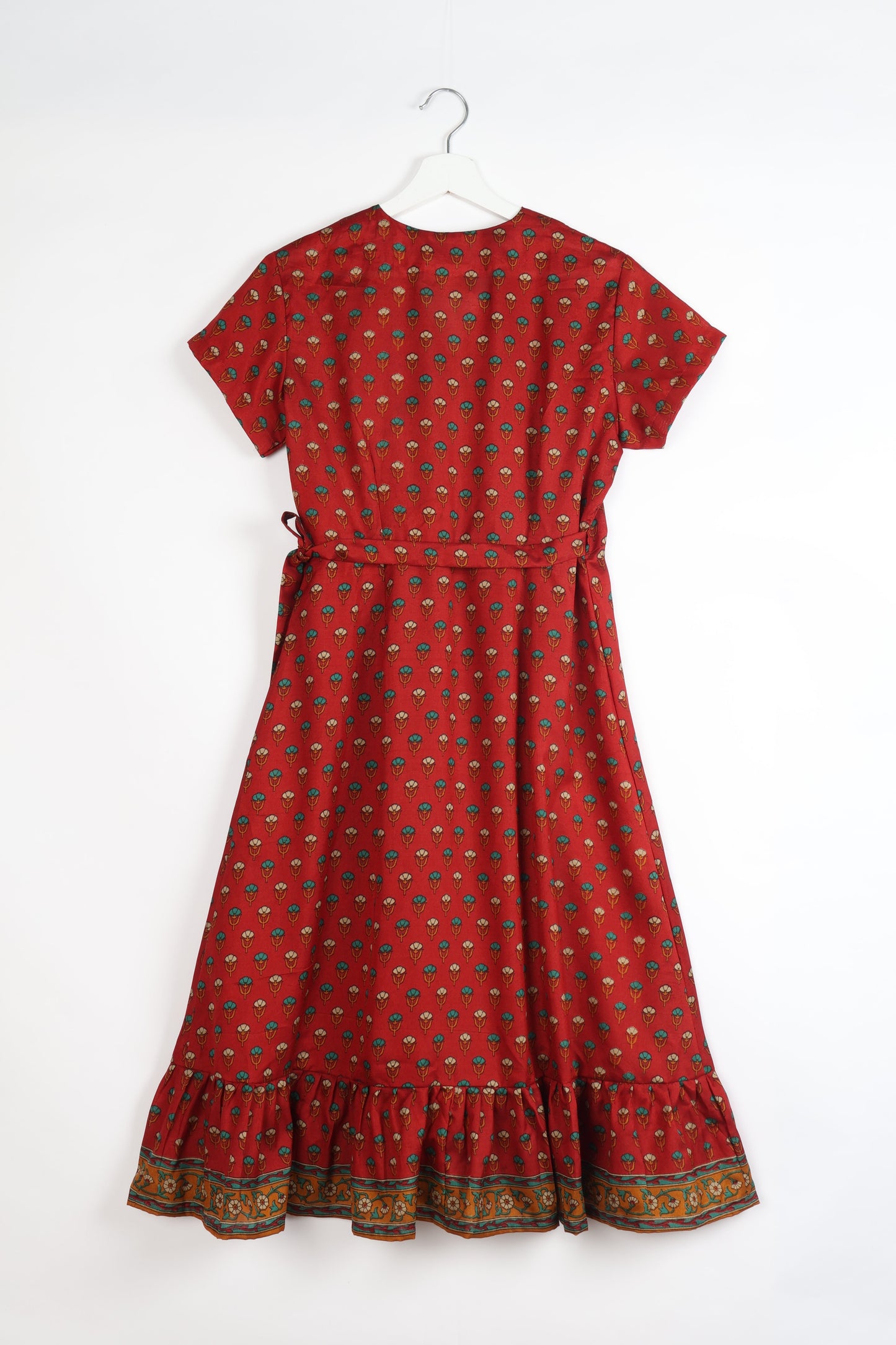 Embrace timeless elegance with our MIDI WRAP DRESS – a midi-length beauty featuring a v-neck, flattery from all angles, and a charming sari belt. Crafted from sustainable materials, this dress embodies ethical clothing and green fashion. Sophisticated with a frill tier at the hem and short cap sleeves, this dress is perfect for any occasion. Tie up the beautifully crafted sari belt on the side for a versatile, stylish, and eco-friendly look.