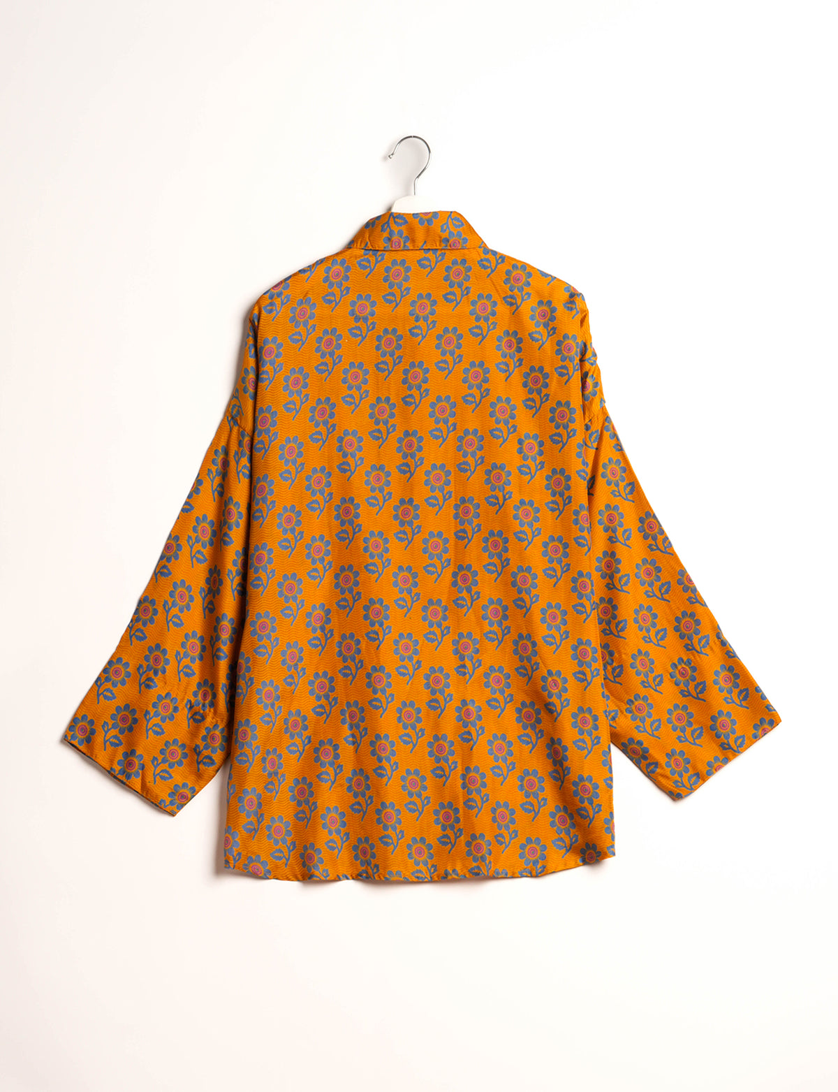 Experience chic comfort with our OVERSIZED SHIRT – a one-of-a-kind piece crafted from sari waste by talented Indian female artisans. With 3/4 length sleeves, a regular shirt collar, and a contrasting inner collar band, this shirt is perfect for work or casual hangouts. Versatile and stylish, it pairs effortlessly over a shift dress, jumpsuit, or with pants.