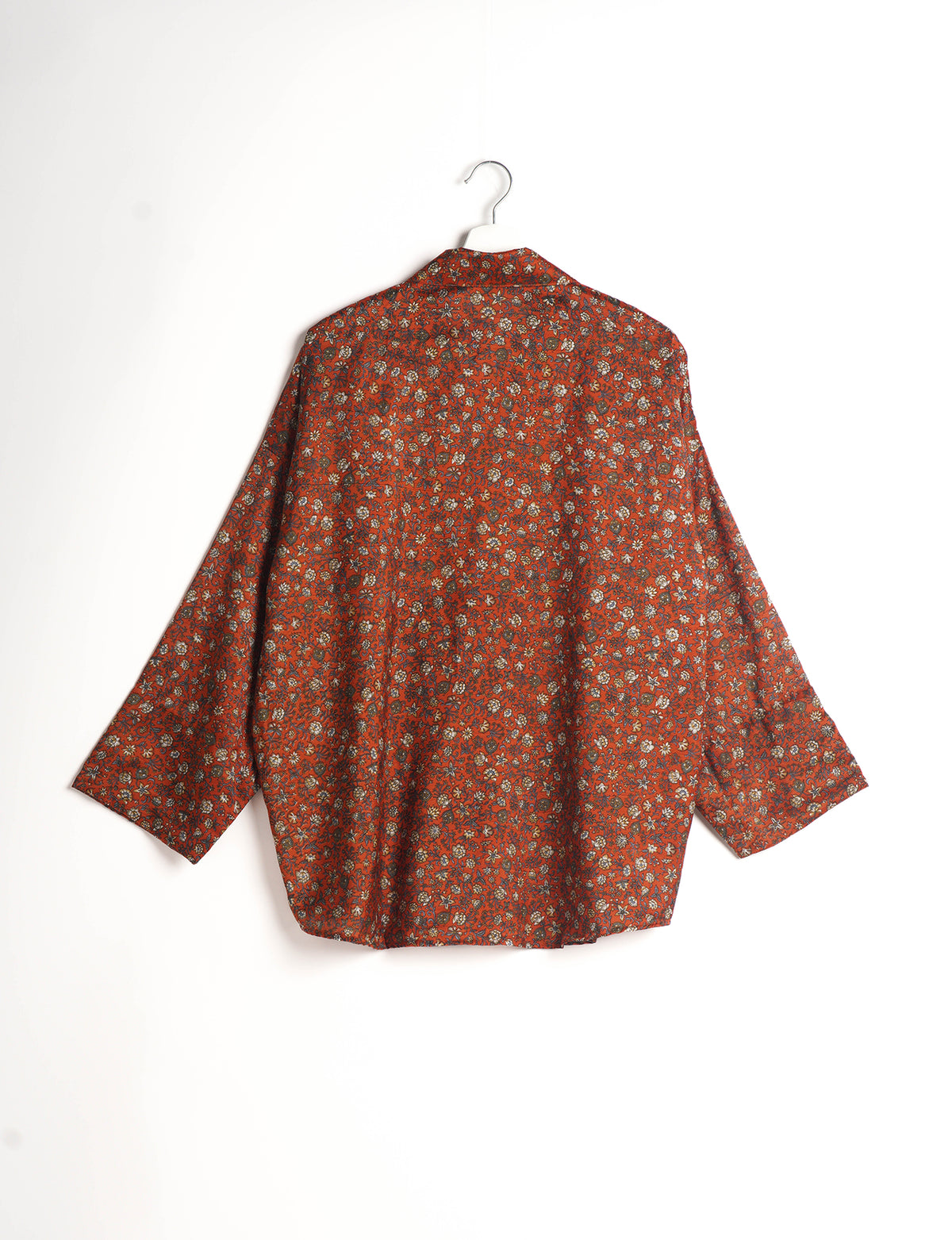 Experience chic comfort with our OVERSIZED SHIRT – a one-of-a-kind piece crafted from sari waste by talented Indian female artisans. With 3/4 length sleeves, a regular shirt collar, and a contrasting inner collar band, this shirt is perfect for work or casual hangouts. Versatile and stylish, it pairs effortlessly over a shift dress, jumpsuit, or with pants.