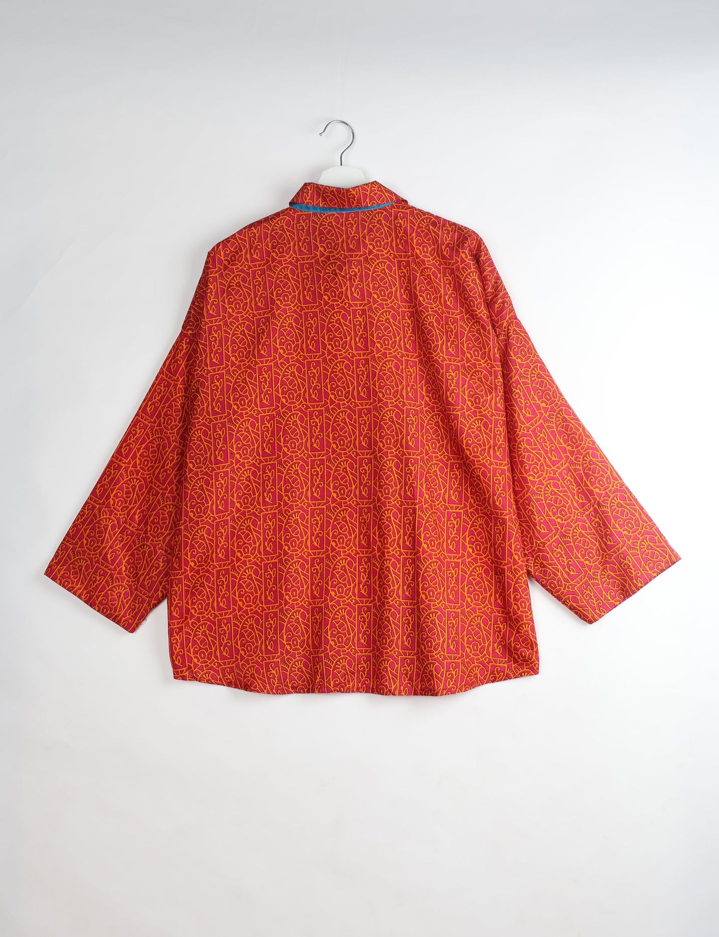 Experience chic comfort with our OVERSIZED SHIRT – a one-of-a-kind piece crafted from sari waste by talented Indian female artisans. With 3/4 length sleeves, a regular shirt collar, and a contrasting inner collar band, this shirt is perfect for work or casual hangouts. Versatile and stylish, it pairs effortlessly over a shift dress, jumpsuit, or with pants.