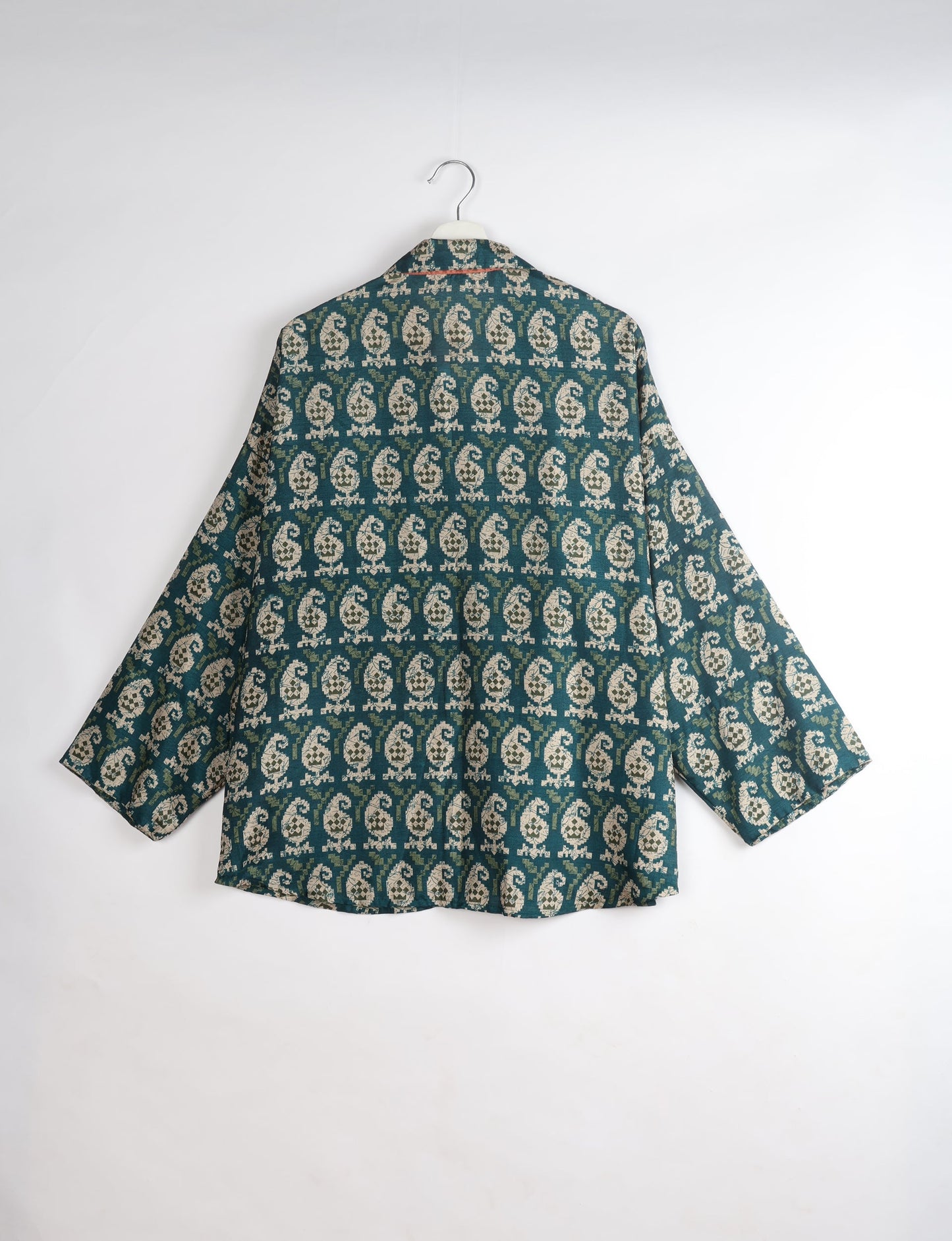 Experience chic comfort with our OVERSIZED SHIRT – a one-of-a-kind piece crafted from sari waste by talented Indian female artisans. With 3/4 length sleeves, a regular shirt collar, and a contrasting inner collar band, this shirt is perfect for work or casual hangouts. Versatile and stylish, it pairs effortlessly over a shift dress, jumpsuit, or with pants.