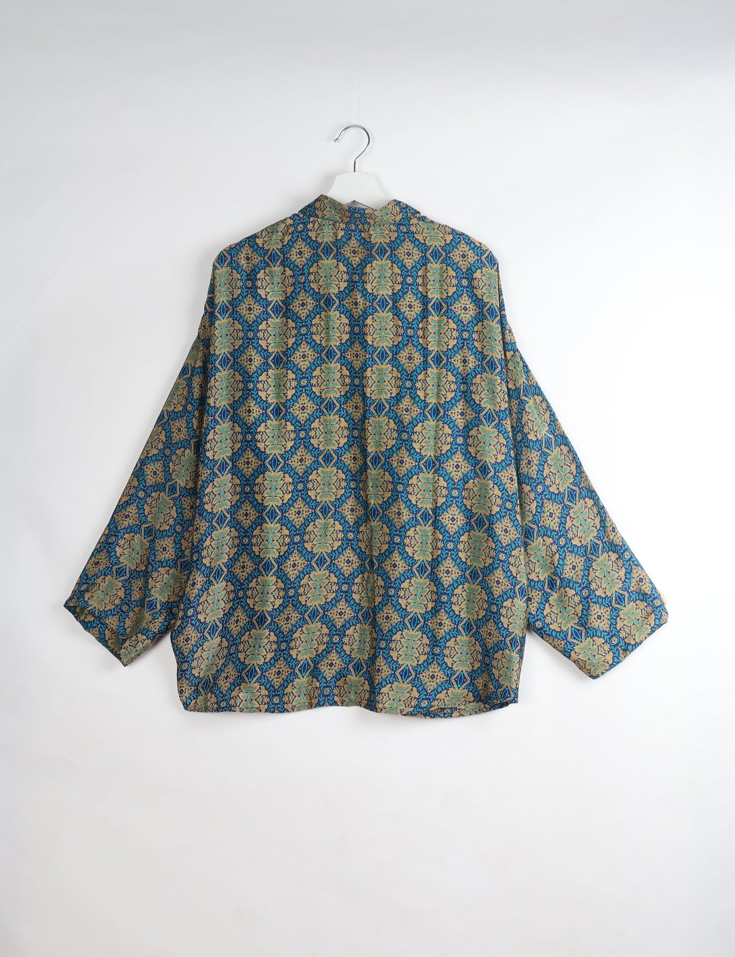 Experience chic comfort with our OVERSIZED SHIRT – a one-of-a-kind piece crafted from sari waste by talented Indian female artisans. With 3/4 length sleeves, a regular shirt collar, and a contrasting inner collar band, this shirt is perfect for work or casual hangouts. Versatile and stylish, it pairs effortlessly over a shift dress, jumpsuit, or with pants.