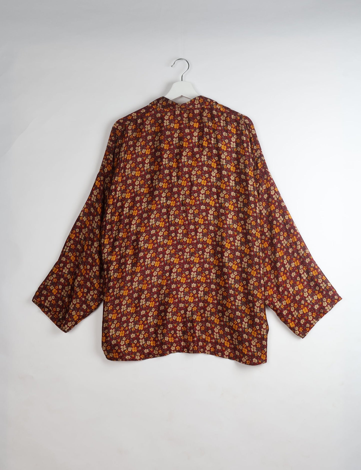 Experience chic comfort with our OVERSIZED SHIRT – a one-of-a-kind piece crafted from sari waste by talented Indian female artisans. With 3/4 length sleeves, a regular shirt collar, and a contrasting inner collar band, this shirt is perfect for work or casual hangouts. Versatile and stylish, it pairs effortlessly over a shift dress, jumpsuit, or with pants.