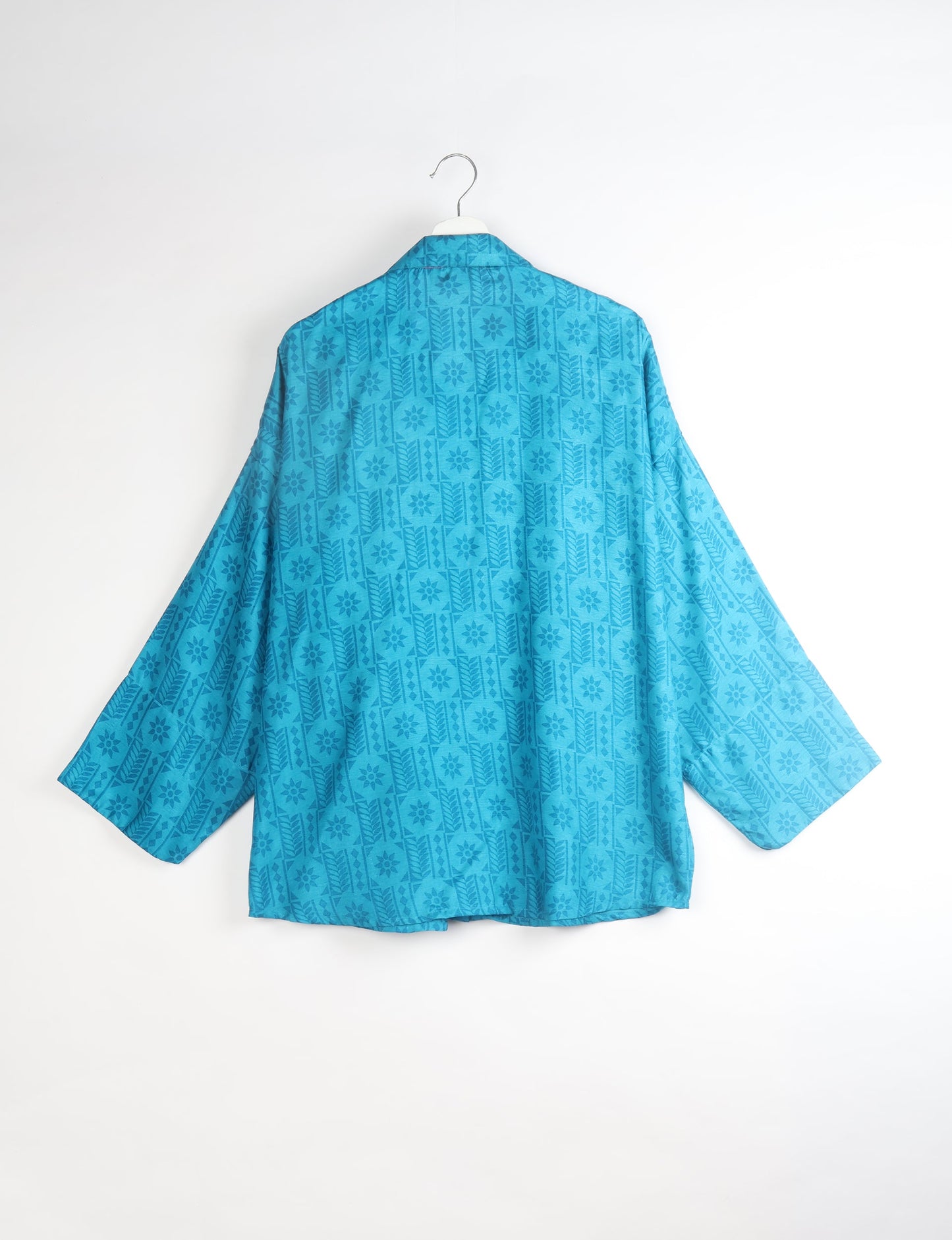 Experience chic comfort with our OVERSIZED SHIRT – a one-of-a-kind piece crafted from sari waste by talented Indian female artisans. With 3/4 length sleeves, a regular shirt collar, and a contrasting inner collar band, this shirt is perfect for work or casual hangouts. Versatile and stylish, it pairs effortlessly over a shift dress, jumpsuit, or with pants.