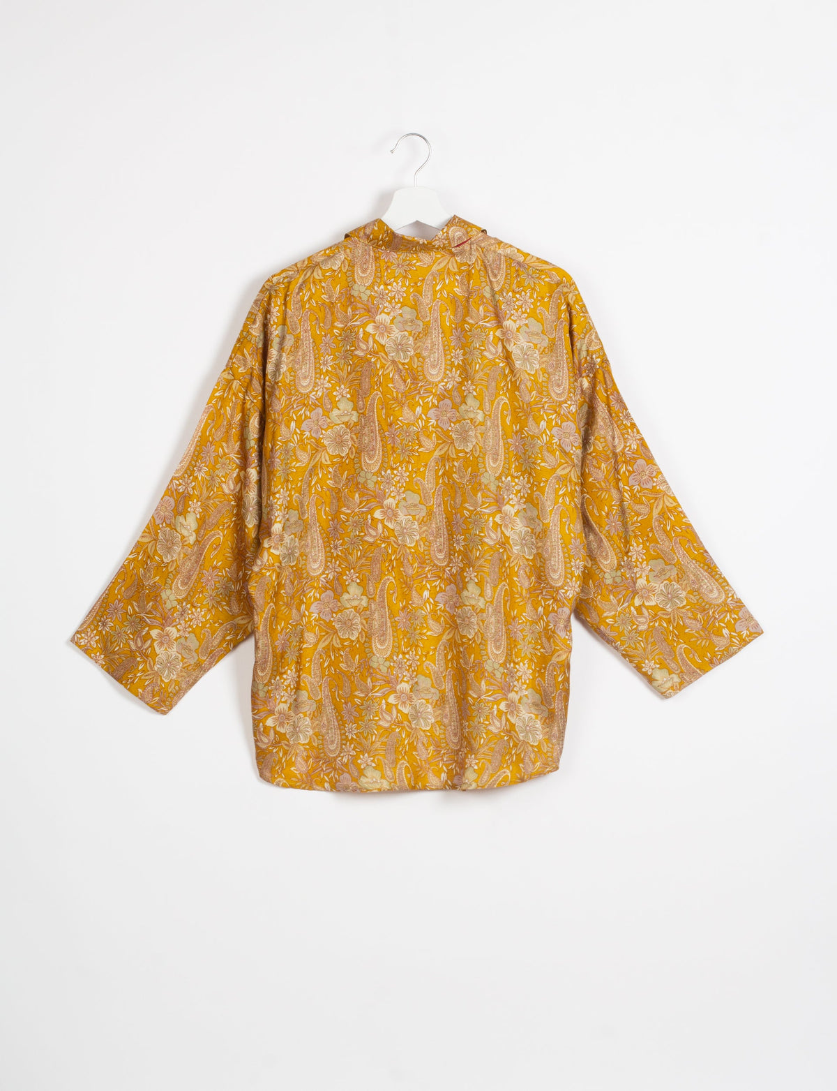 Experience chic comfort with our OVERSIZED SHIRT – a one-of-a-kind piece crafted from sari waste by talented Indian female artisans. With 3/4 length sleeves, a regular shirt collar, and a contrasting inner collar band, this shirt is perfect for work or casual hangouts. Versatile and stylish, it pairs effortlessly over a shift dress, jumpsuit, or with pants.