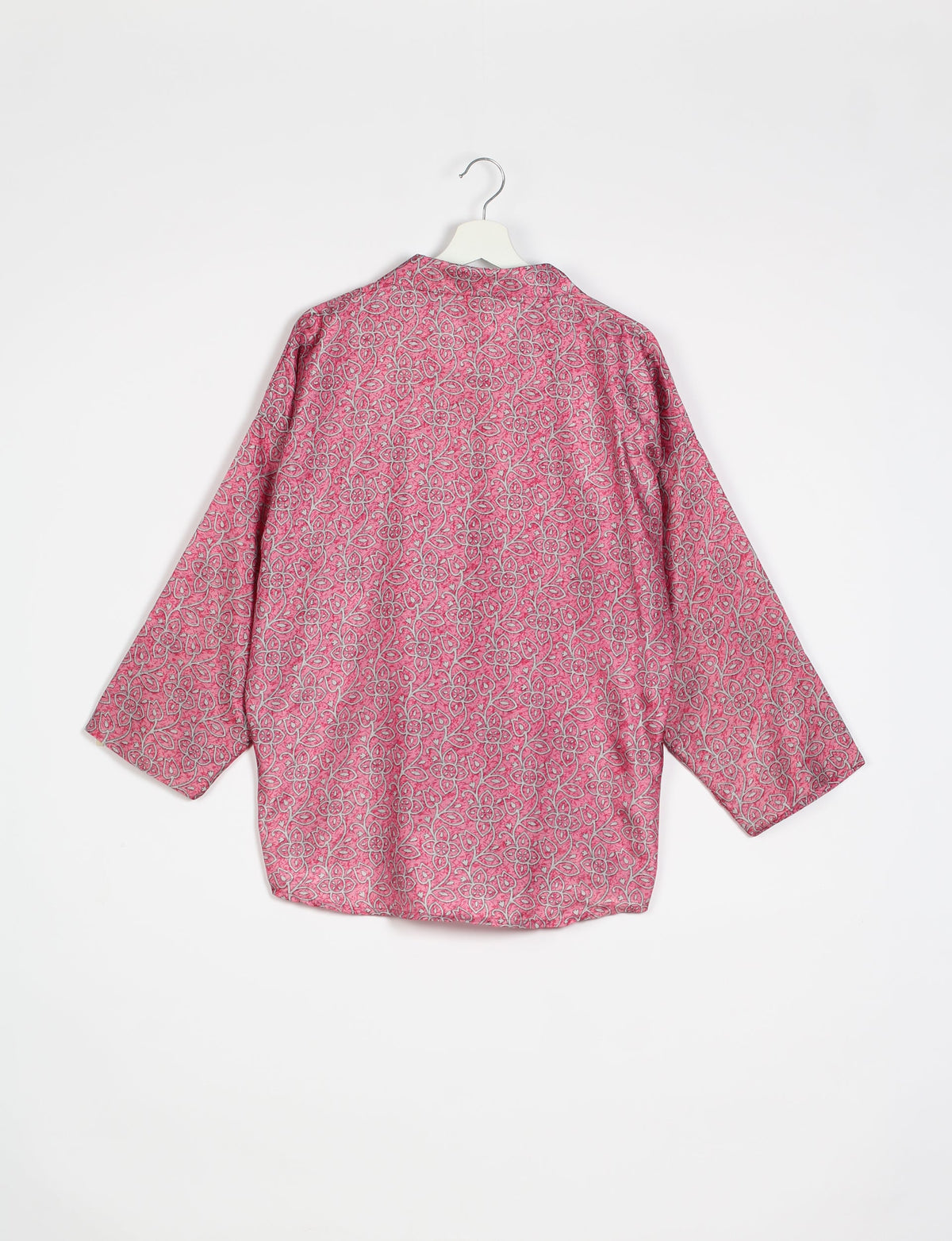 Experience chic comfort with our OVERSIZED SHIRT – a one-of-a-kind piece crafted from sari waste by talented Indian female artisans. With 3/4 length sleeves, a regular shirt collar, and a contrasting inner collar band, this shirt is perfect for work or casual hangouts. Versatile and stylish, it pairs effortlessly over a shift dress, jumpsuit, or with pants.