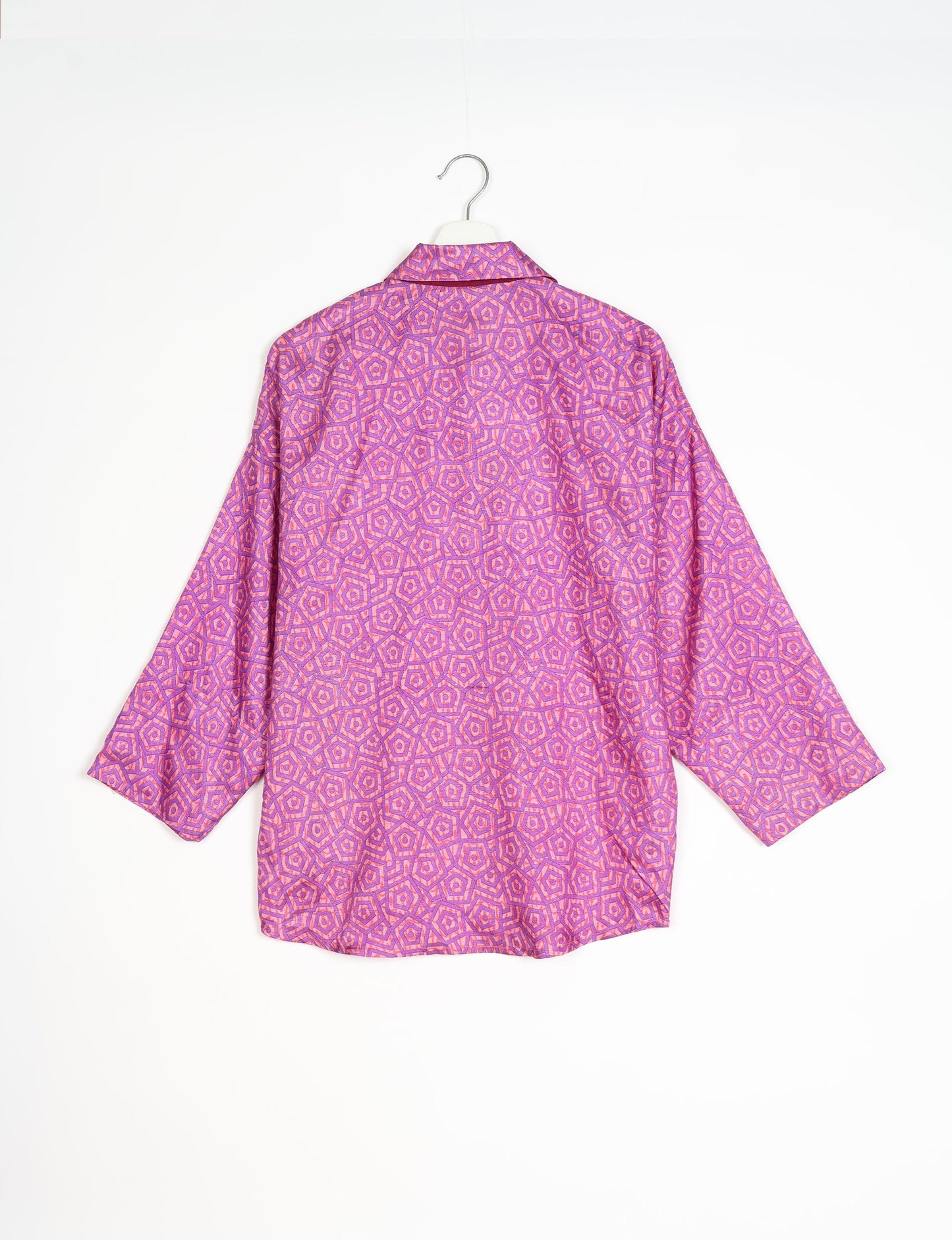 Experience chic comfort with our OVERSIZED SHIRT – a one-of-a-kind piece crafted from sari waste by talented Indian female artisans. With 3/4 length sleeves, a regular shirt collar, and a contrasting inner collar band, this shirt is perfect for work or casual hangouts. Versatile and stylish, it pairs effortlessly over a shift dress, jumpsuit, or with pants.