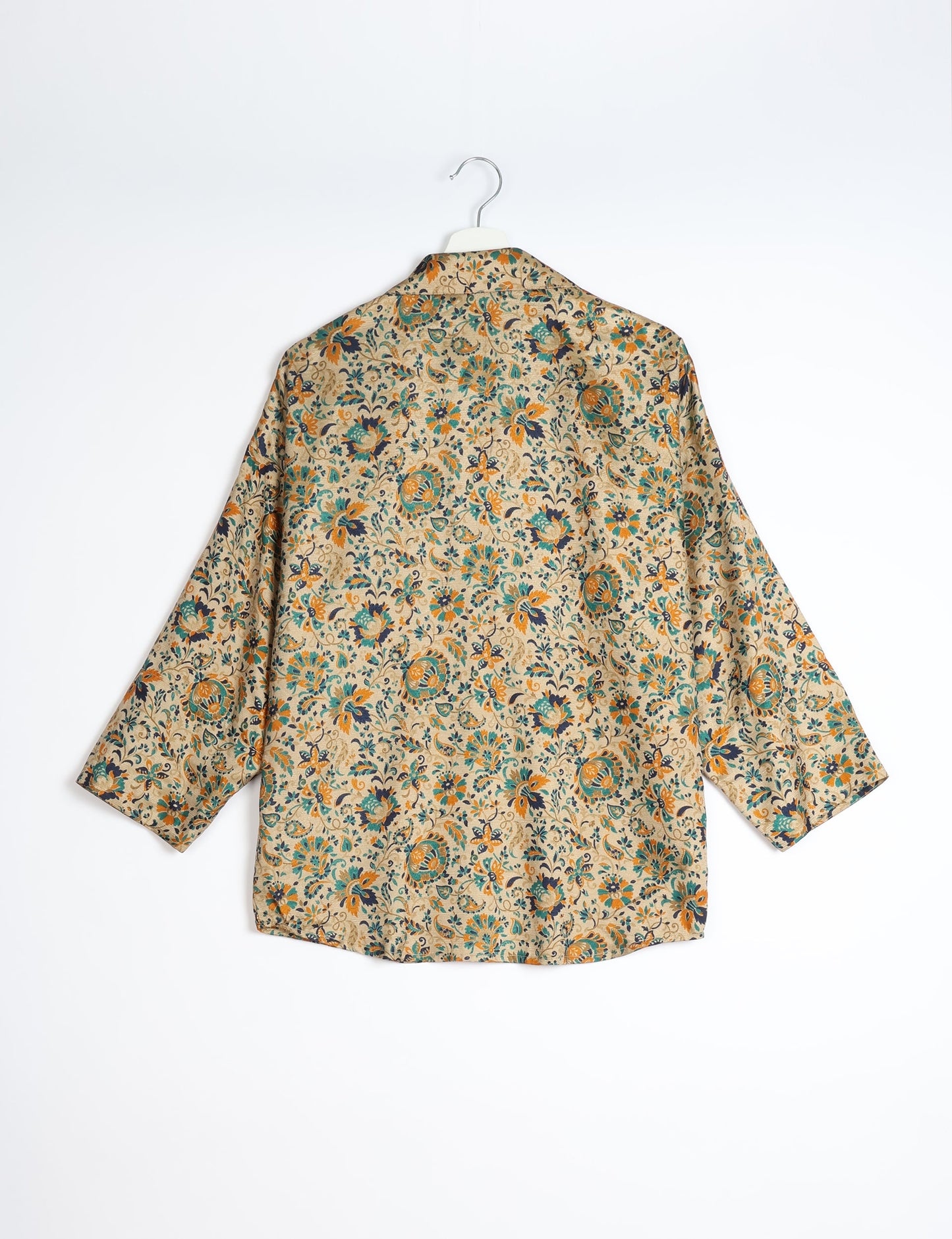 Experience chic comfort with our OVERSIZED SHIRT – a one-of-a-kind piece crafted from sari waste by talented Indian female artisans. With 3/4 length sleeves, a regular shirt collar, and a contrasting inner collar band, this shirt is perfect for work or casual hangouts. Versatile and stylish, it pairs effortlessly over a shift dress, jumpsuit, or with pants.