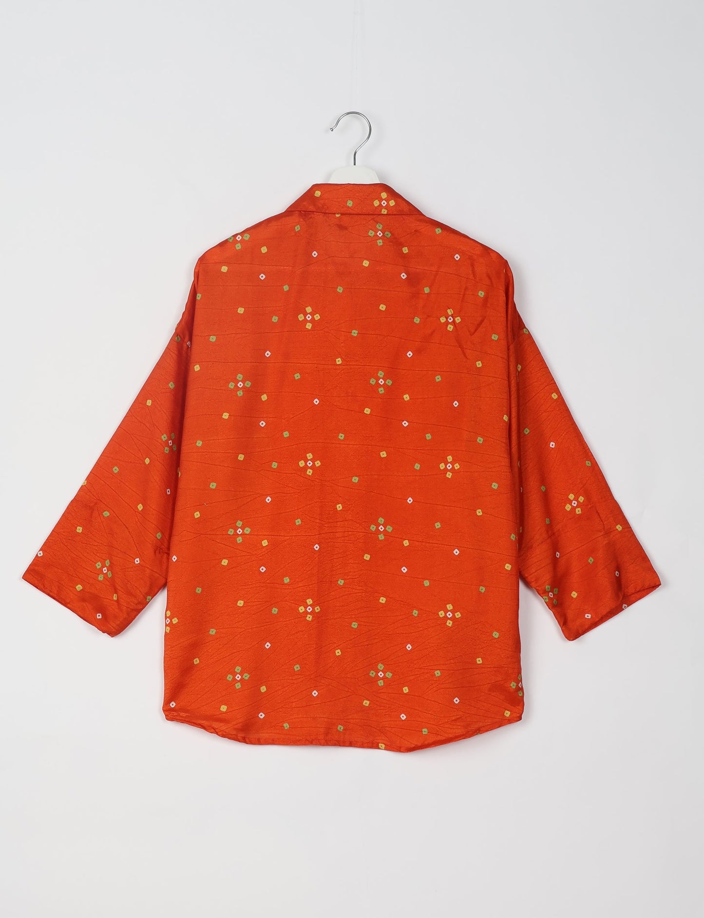 Experience chic comfort with our OVERSIZED SHIRT – a one-of-a-kind piece crafted from sari waste by talented Indian female artisans. With 3/4 length sleeves, a regular shirt collar, and a contrasting inner collar band, this shirt is perfect for work or casual hangouts. Versatile and stylish, it pairs effortlessly over a shift dress, jumpsuit, or with pants.