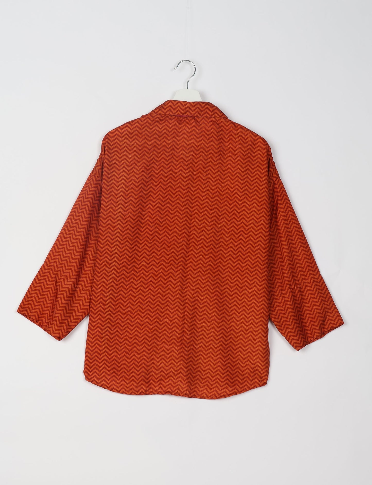 Experience chic comfort with our OVERSIZED SHIRT – a one-of-a-kind piece crafted from sari waste by talented Indian female artisans. With 3/4 length sleeves, a regular shirt collar, and a contrasting inner collar band, this shirt is perfect for work or casual hangouts. Versatile and stylish, it pairs effortlessly over a shift dress, jumpsuit, or with pants.