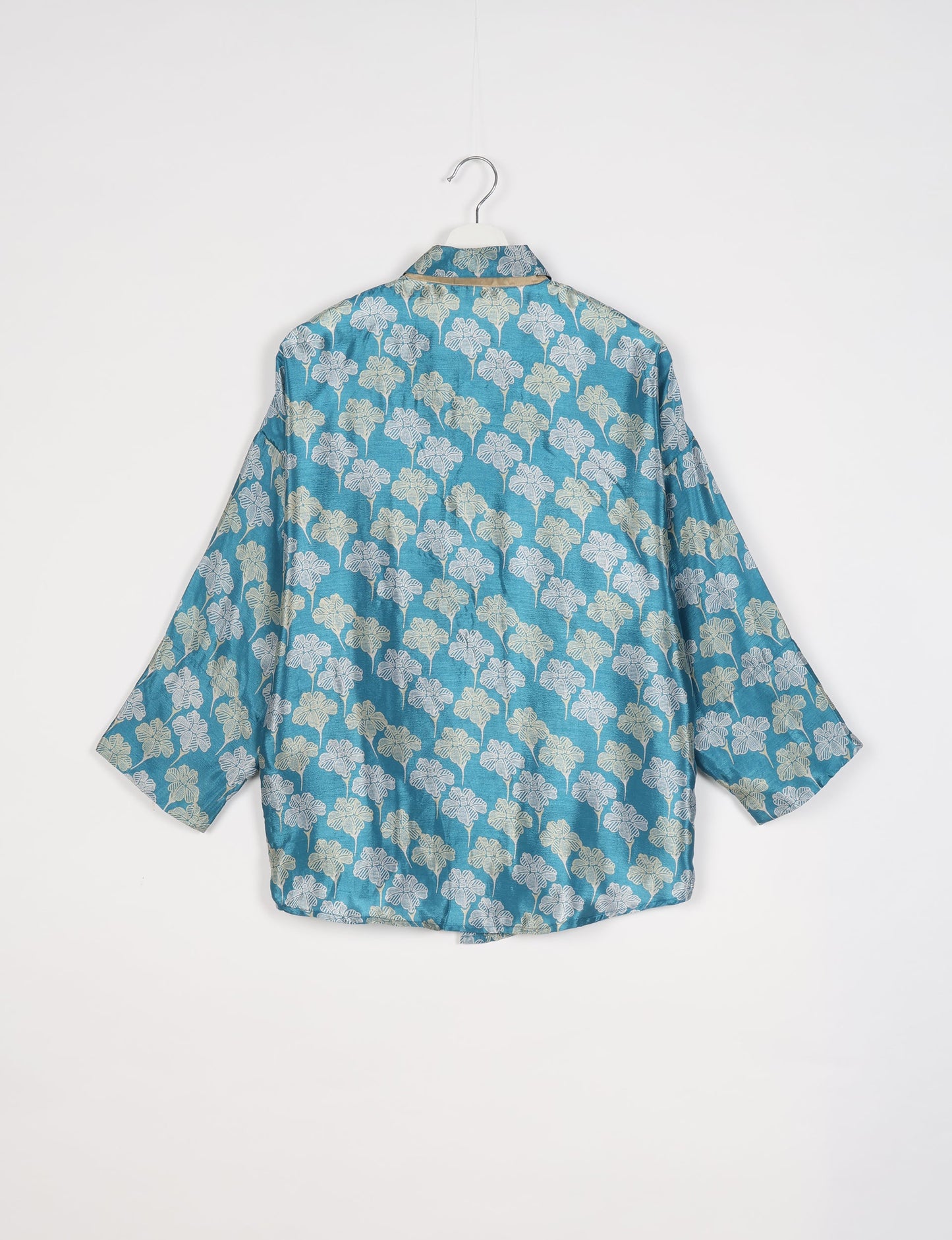 Experience chic comfort with our OVERSIZED SHIRT – a one-of-a-kind piece crafted from sari waste by talented Indian female artisans. With 3/4 length sleeves, a regular shirt collar, and a contrasting inner collar band, this shirt is perfect for work or casual hangouts. Versatile and stylish, it pairs effortlessly over a shift dress, jumpsuit, or with pants.