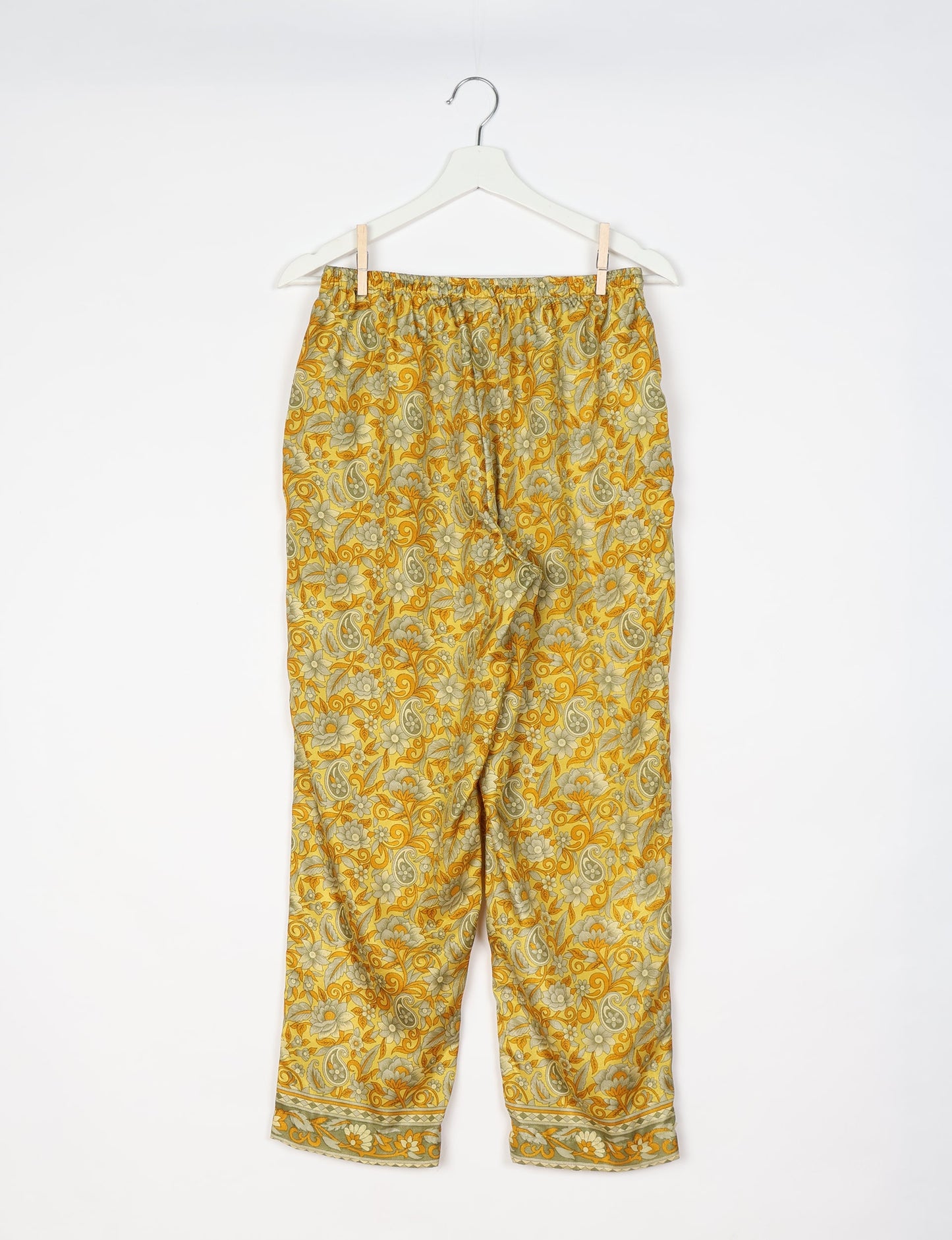 Elevate your wardrobe with our planet-friendly PULL-ON PANTS. Made from upcycled sari fabric, these eco-conscious pants offer a drawstring waist for a perfect fit. Tapered leg design ensures both style and comfort. Choose ethical, green fashion that supports artisans and sustainable living.