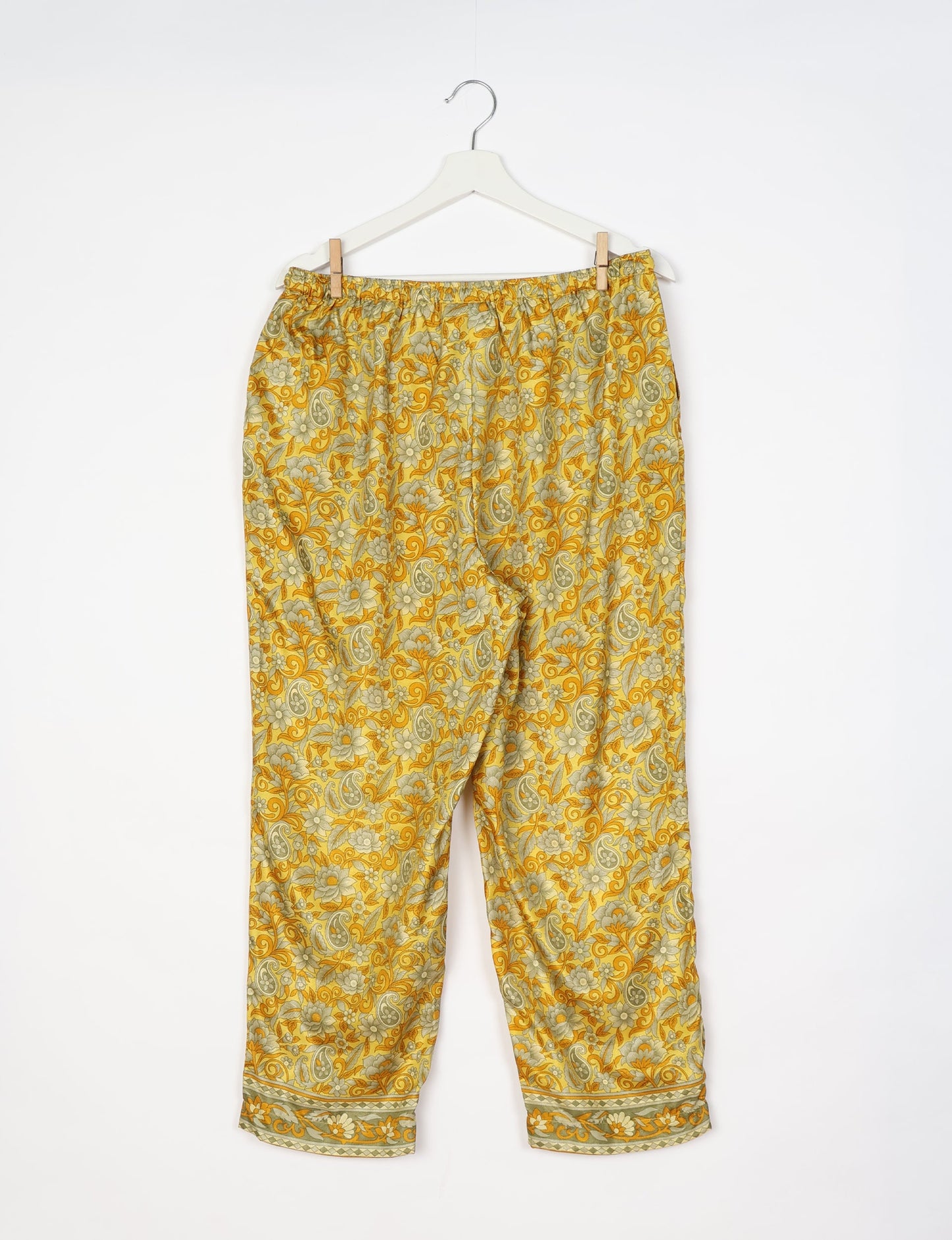 Elevate your wardrobe with our planet-friendly PULL-ON PANTS. Made from upcycled sari fabric, these eco-conscious pants offer a drawstring waist for a perfect fit. Tapered leg design ensures both style and comfort. Choose ethical, green fashion that supports artisans and sustainable living.