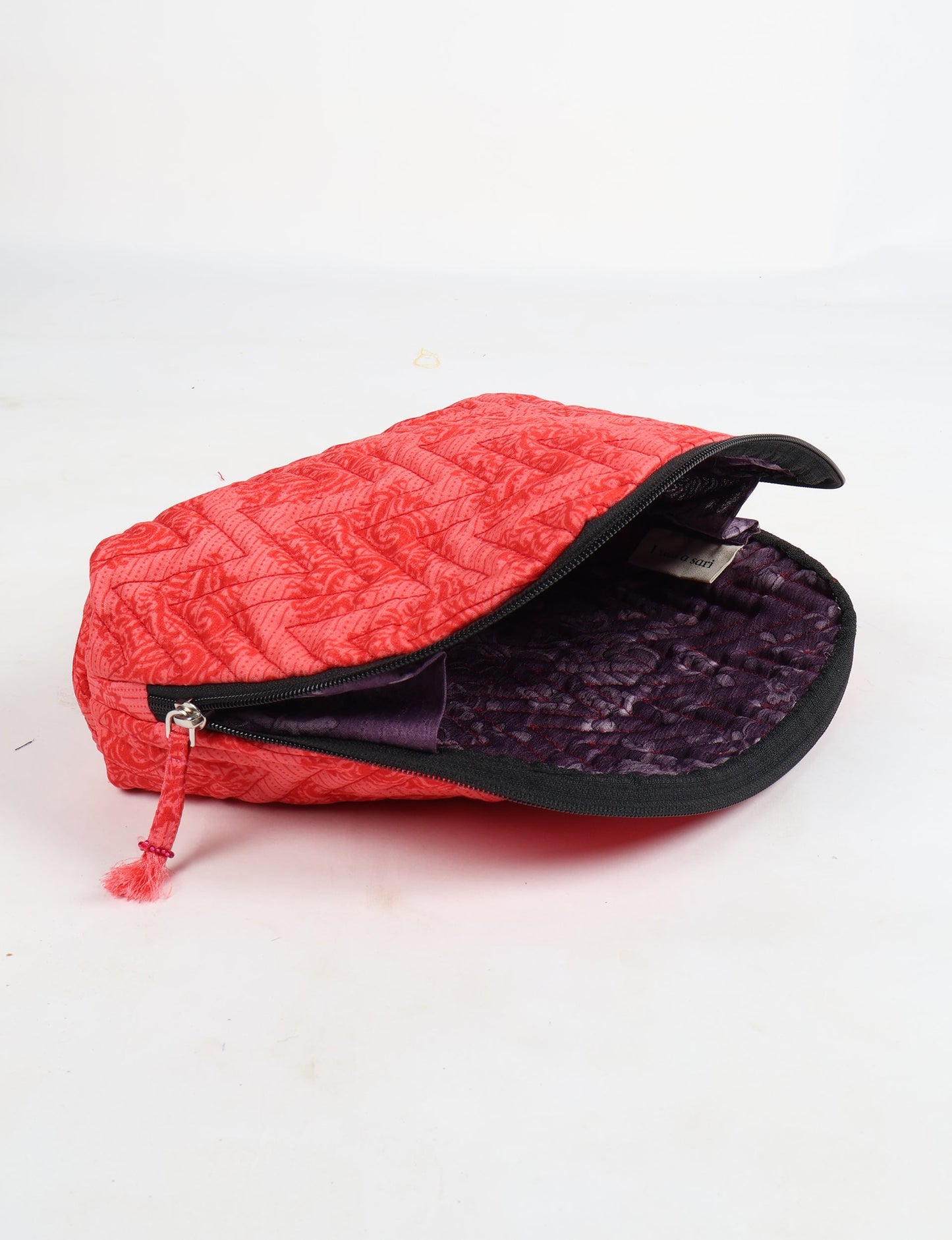 A set of two Vanity Pouches, featuring embellished beaded pullers, made from sustainable materials for eco-conscious travelers.