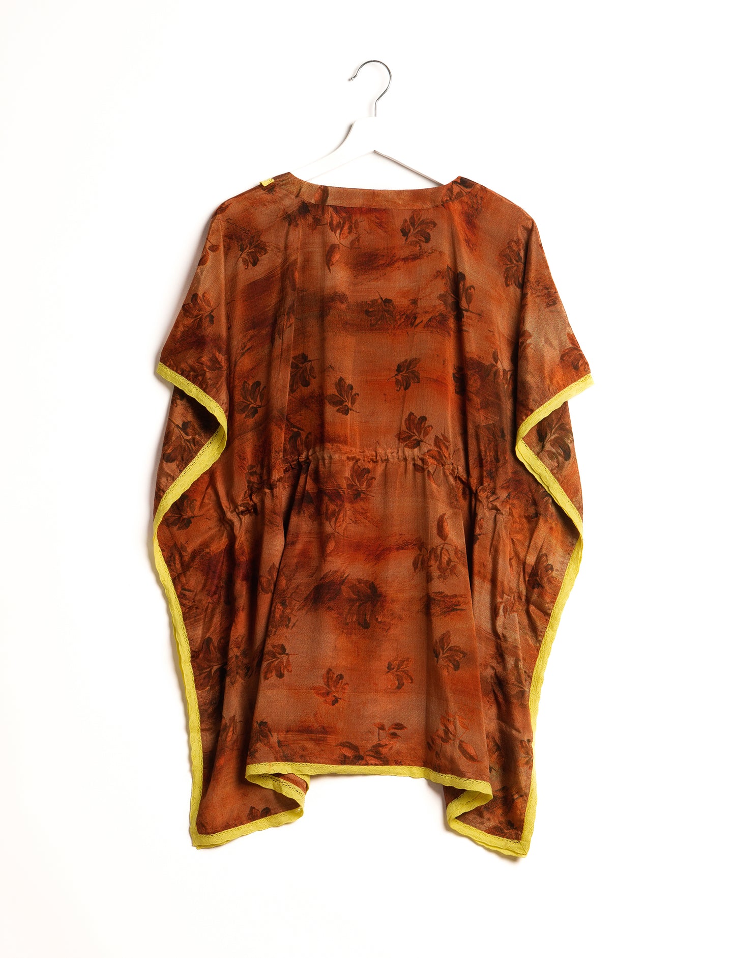 Elevate your style with our short kaftan, a perfect blend of ethical and green fashion. The light and loose-flowing fabric, drawstring waist, beaded tassel ends, and delicate lace edging make it a versatile choice for urban summers, beachwear, or poolside elegance. Enjoy sustainable and fashionable living.