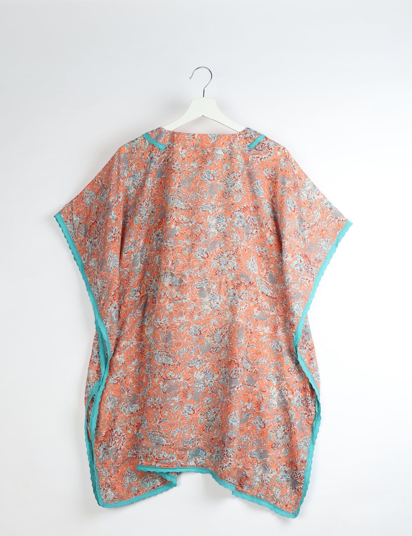 Elevate your style with our short kaftan, a perfect blend of ethical and green fashion. The light and loose-flowing fabric, drawstring waist, beaded tassel ends, and delicate lace edging make it a versatile choice for urban summers, beachwear, or poolside elegance. Enjoy sustainable and fashionable living.