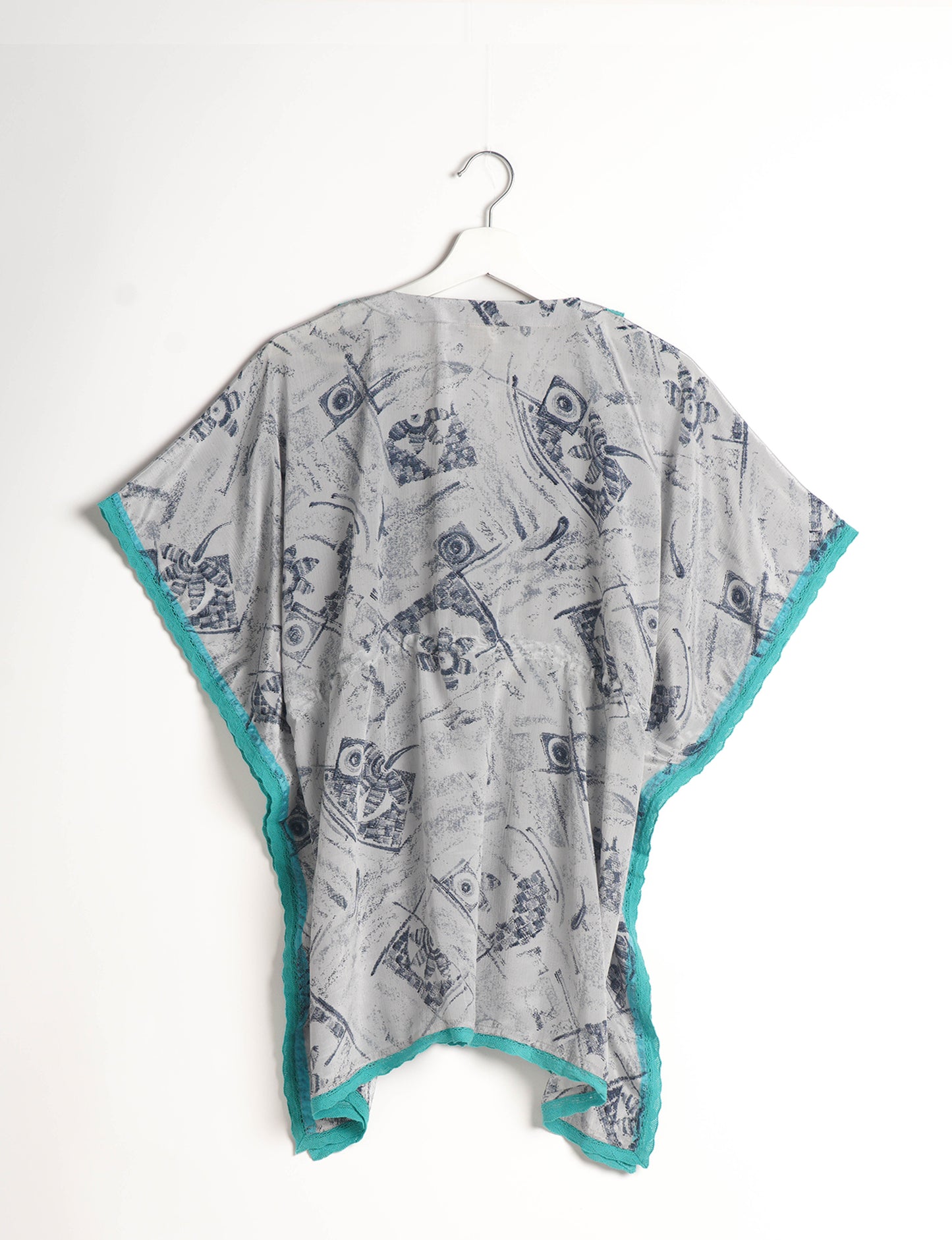 Elevate your style with our short kaftan, a perfect blend of ethical and green fashion. The light and loose-flowing fabric, drawstring waist, beaded tassel ends, and delicate lace edging make it a versatile choice for urban summers, beachwear, or poolside elegance. Enjoy sustainable and fashionable living.