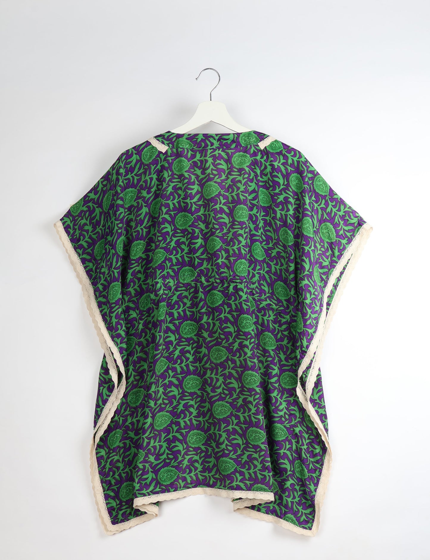Elevate your style with our short kaftan, a perfect blend of ethical and green fashion. The light and loose-flowing fabric, drawstring waist, beaded tassel ends, and delicate lace edging make it a versatile choice for urban summers, beachwear, or poolside elegance. Enjoy sustainable and fashionable living.